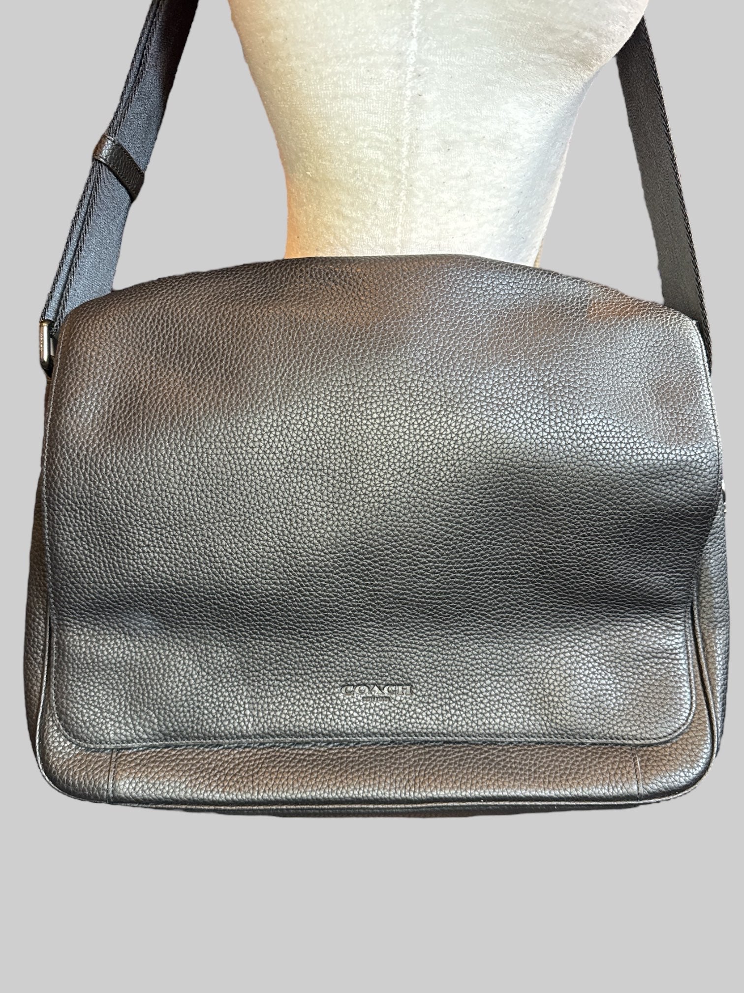 Genuine leather Coach laptop bag with multiple pockets inside, magnetic snap flap, and adjustable shoulder strap