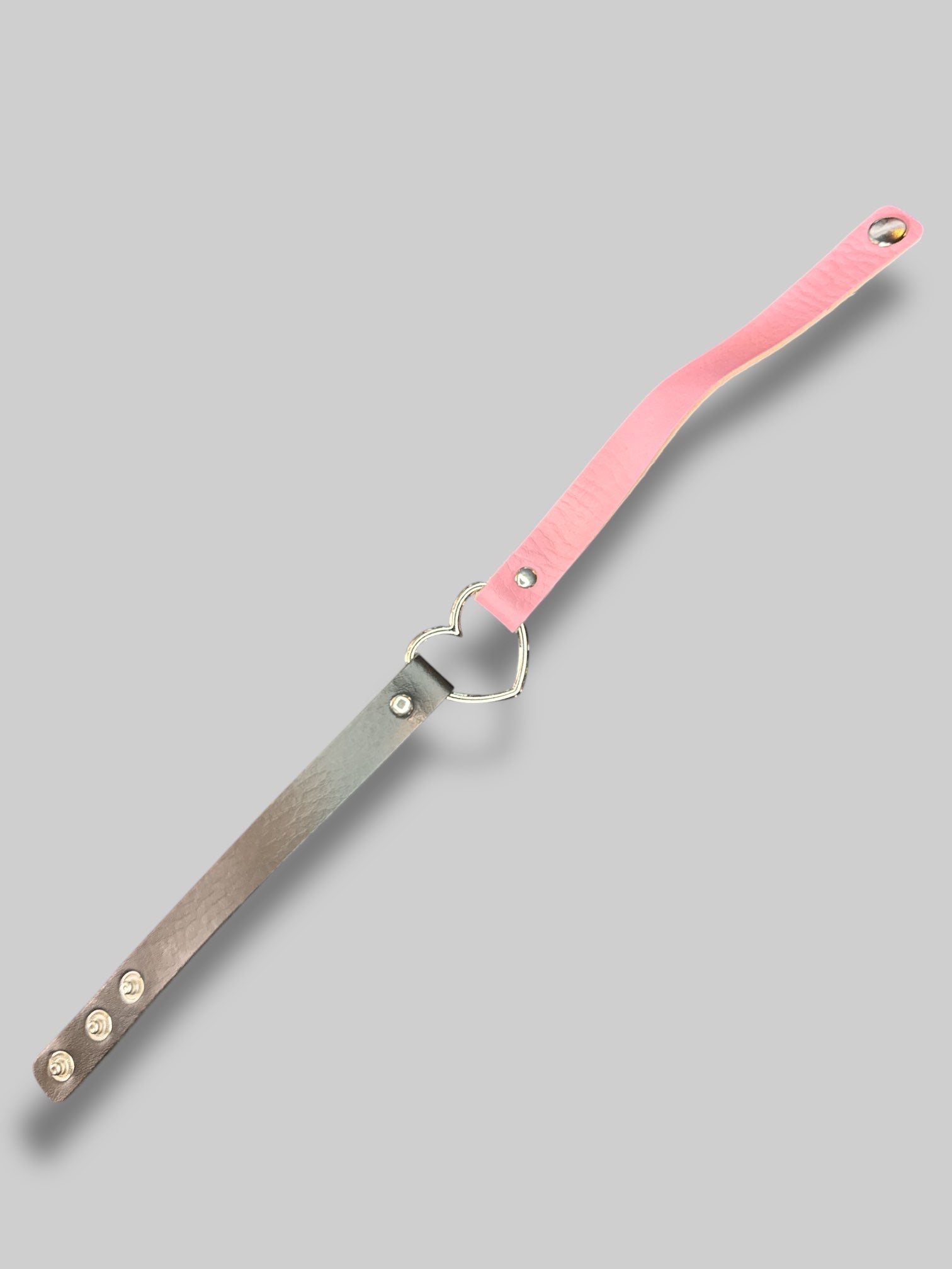Black and pink leather choker with heart ring in middle, and snap button closure