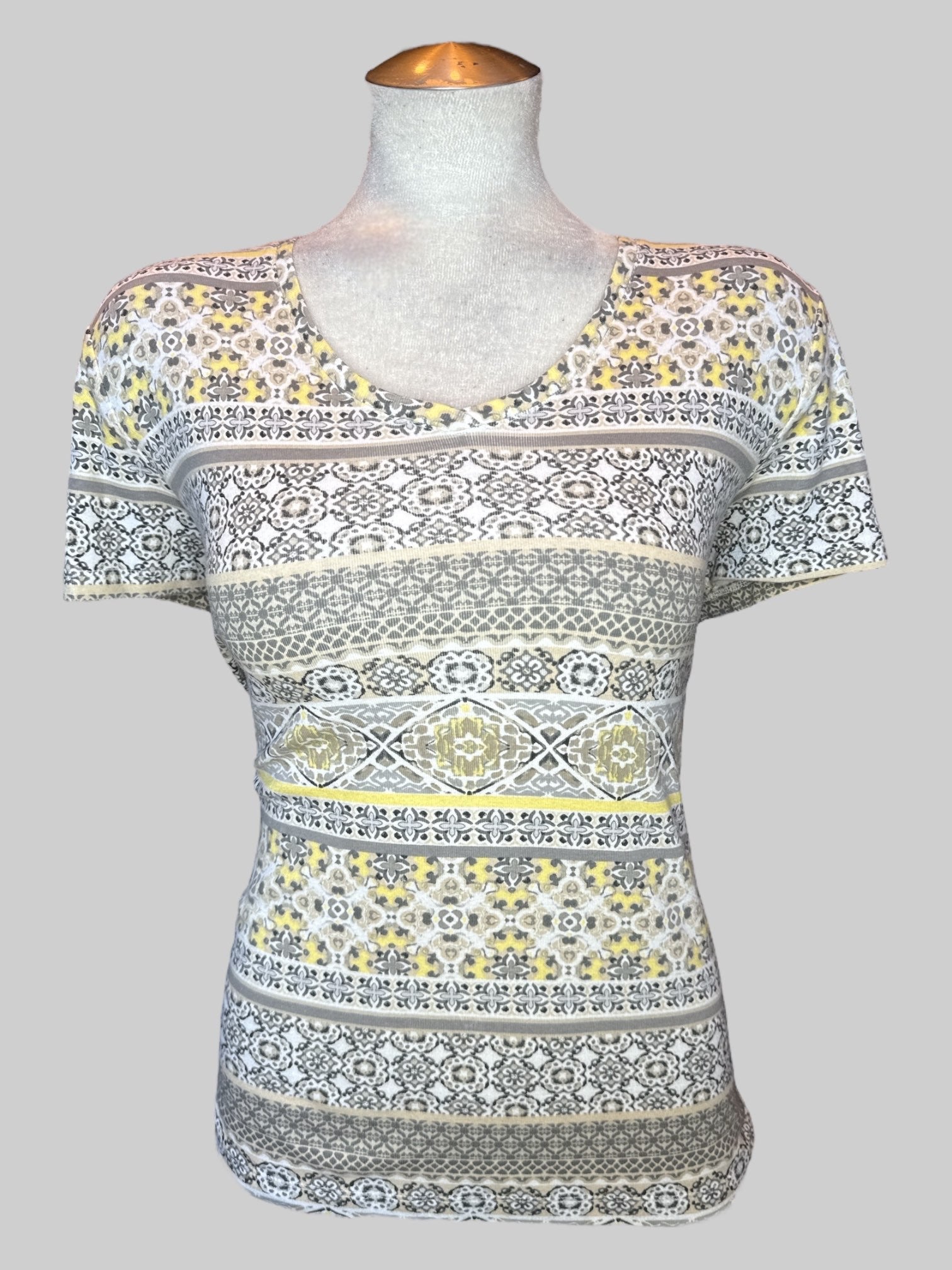 XL White short sleeve shirt with multi pattern yellow, black, gray, tan, and brown geometric designs