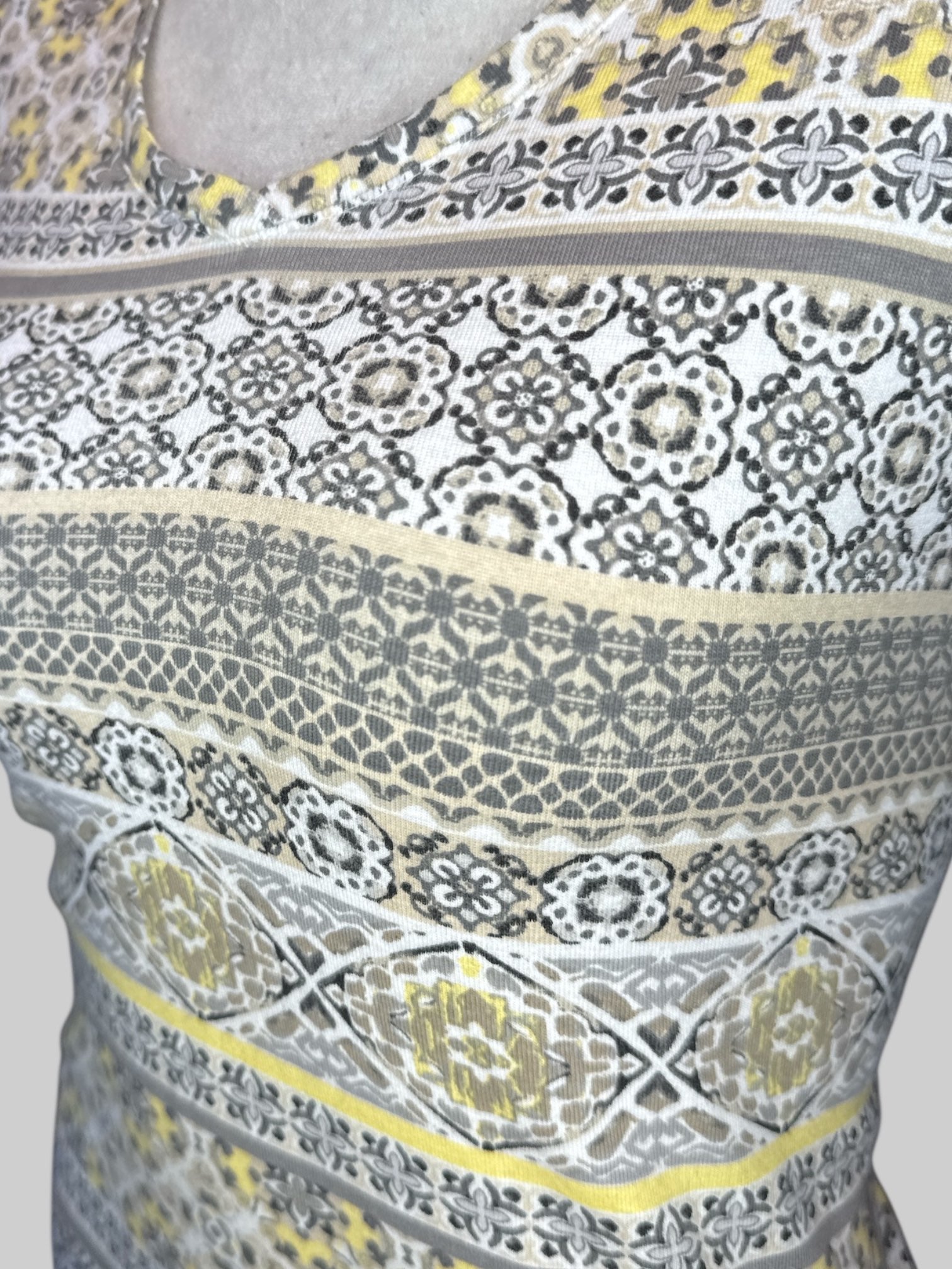 XL White short sleeve shirt with multi pattern yellow, black, gray, tan, and brown geometric designs