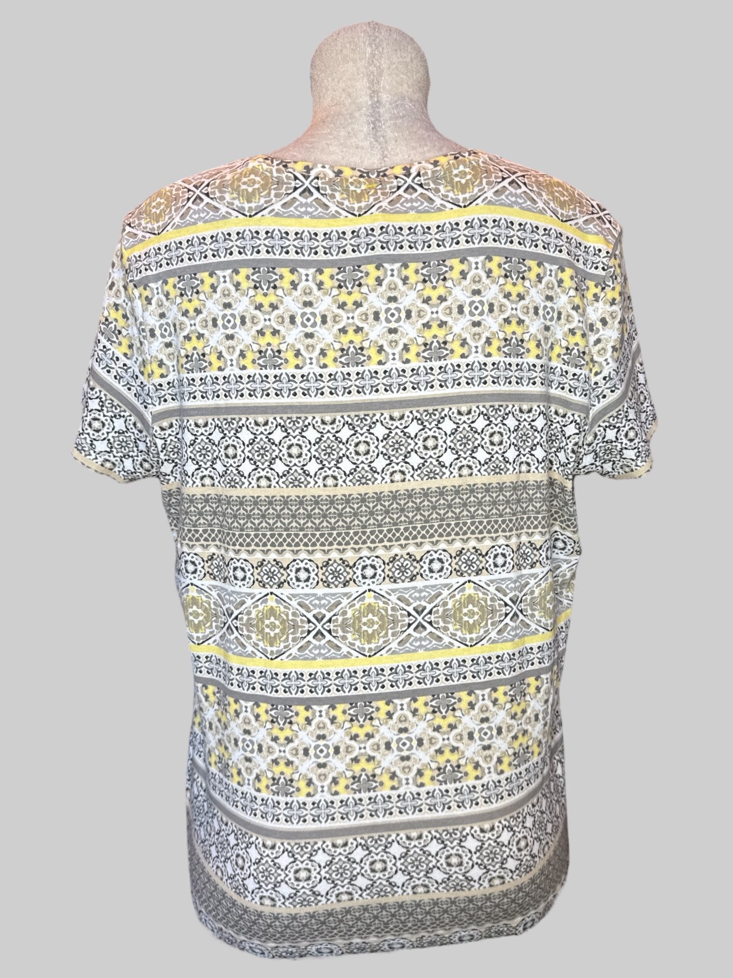 XL White short sleeve shirt with multi pattern yellow, black, gray, tan, and brown geometric designs