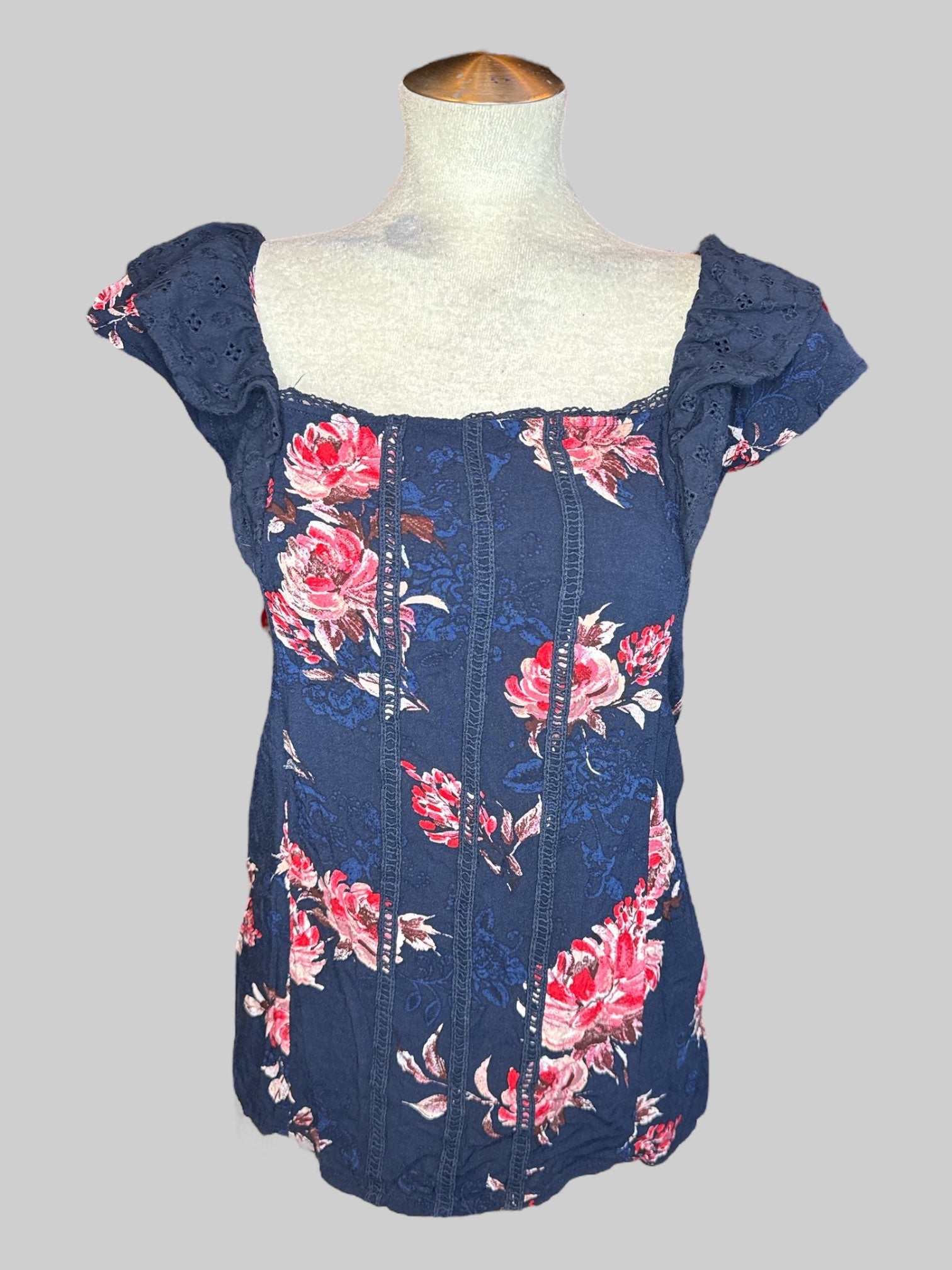 1X Navy blue short sleeve top with pink and red florals, blue florals, and ruffled sleeves