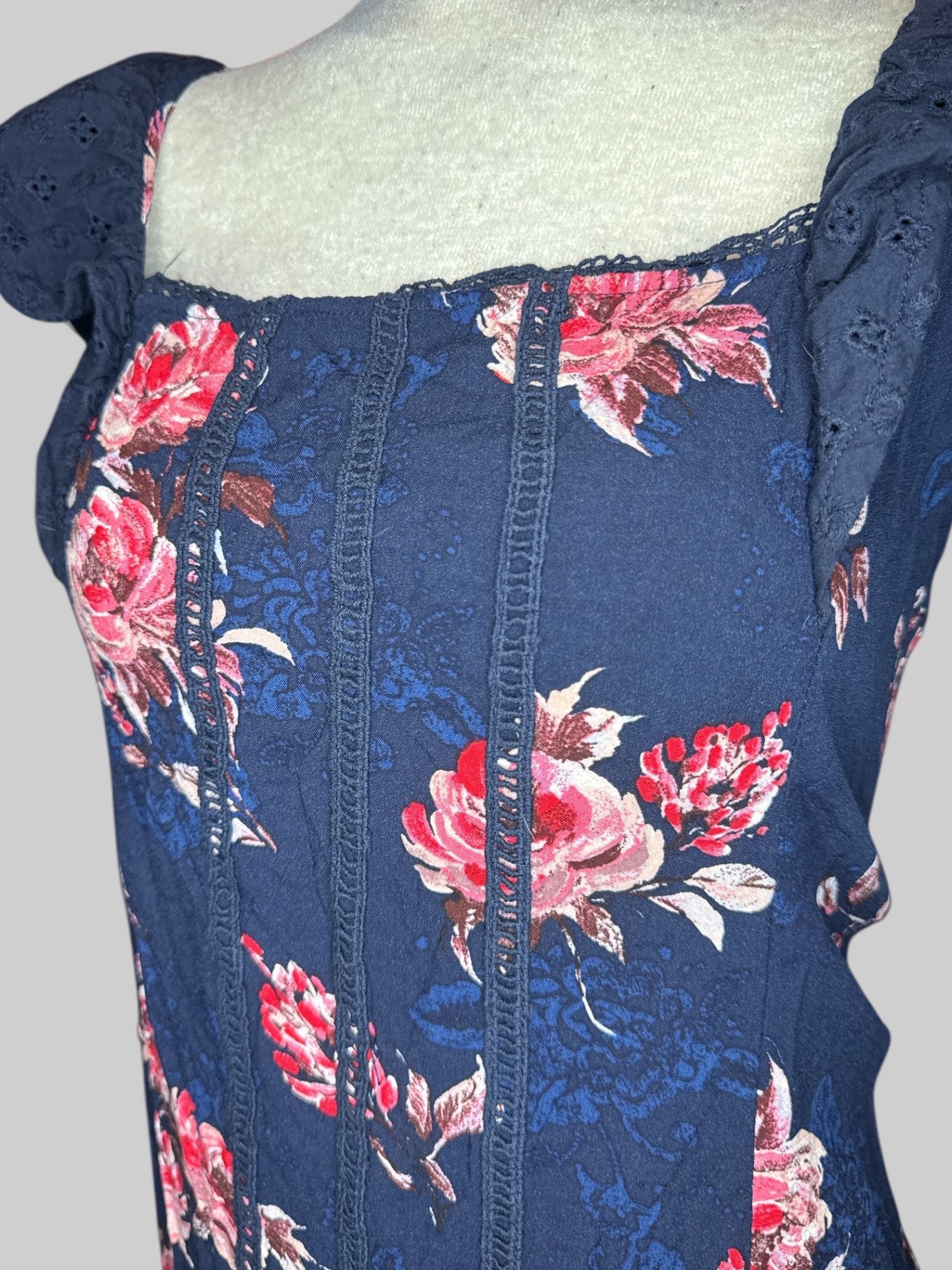 1X Navy blue short sleeve top with pink and red florals, blue florals, and ruffled sleeves