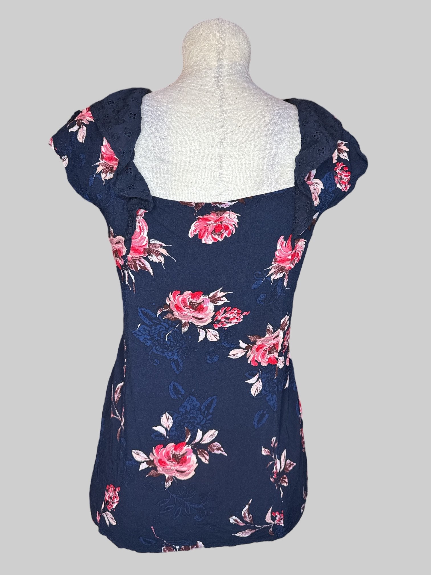 1X Navy blue short sleeve top with pink and red florals, blue florals, and ruffled sleeves