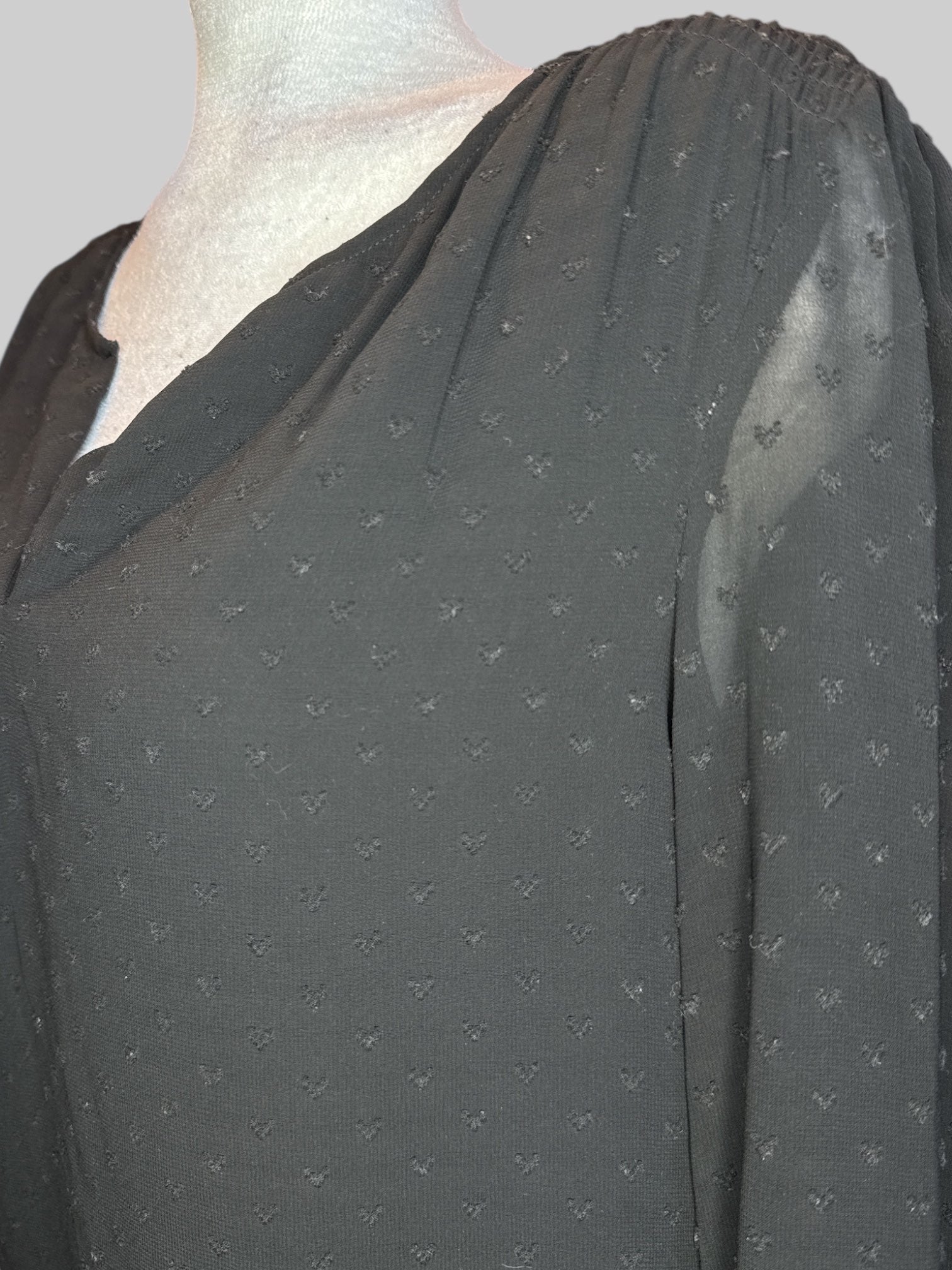 M Black blouse with heart shaped textured polkadots, sheer sleeves, and balloon hem