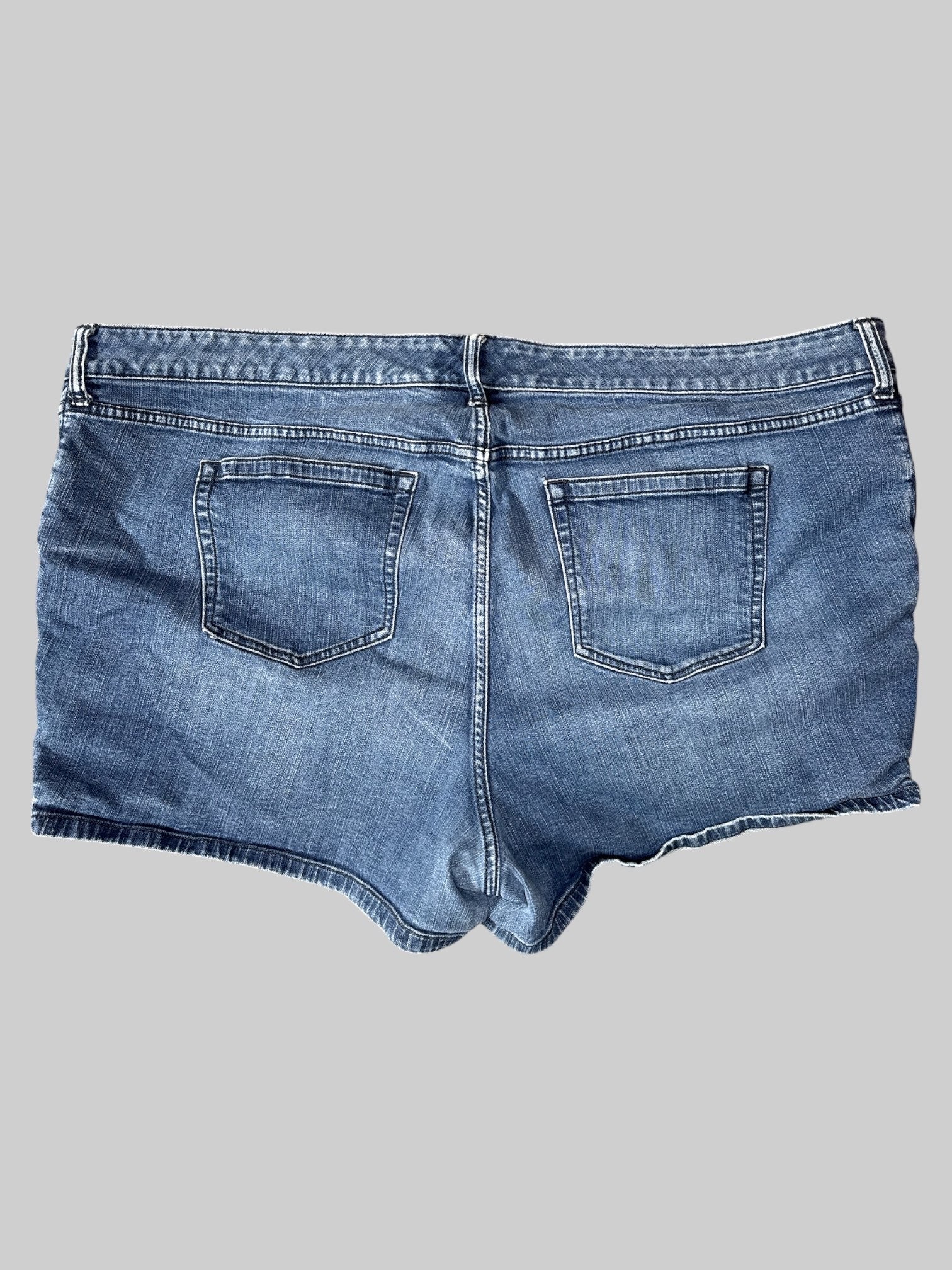 3X Blue denim shorts with multi button closure, pockets, belt, loops, and decorative lacing on sides