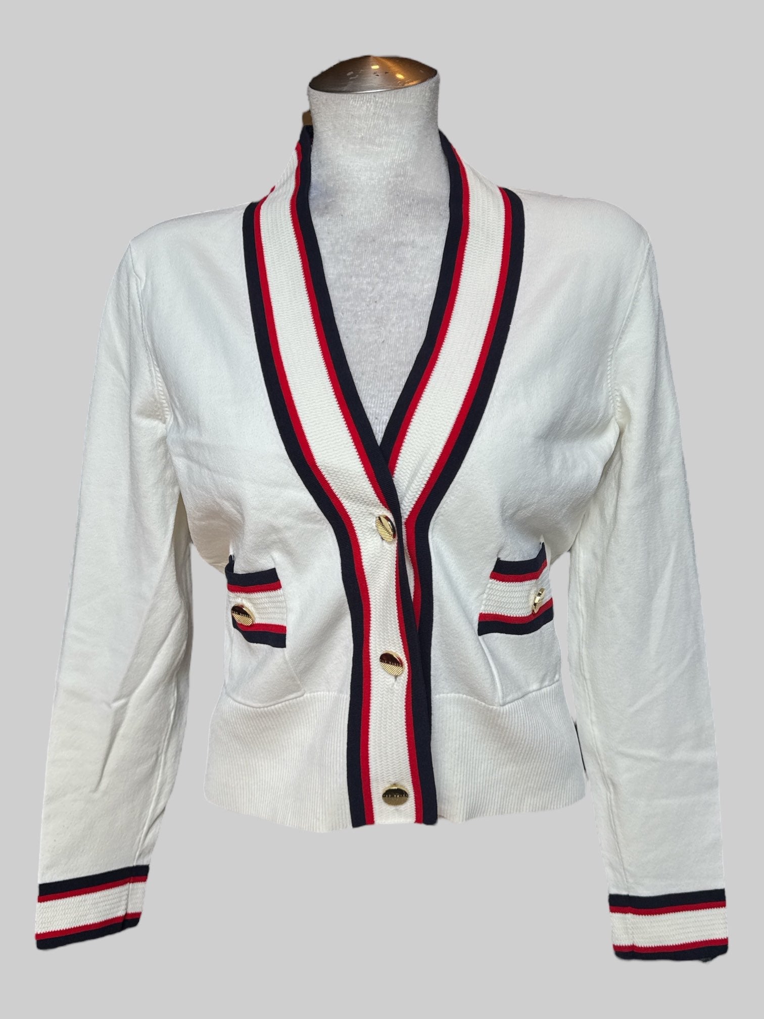 L Ted Baker white button up cardigan with red and blue details and gold color buttons