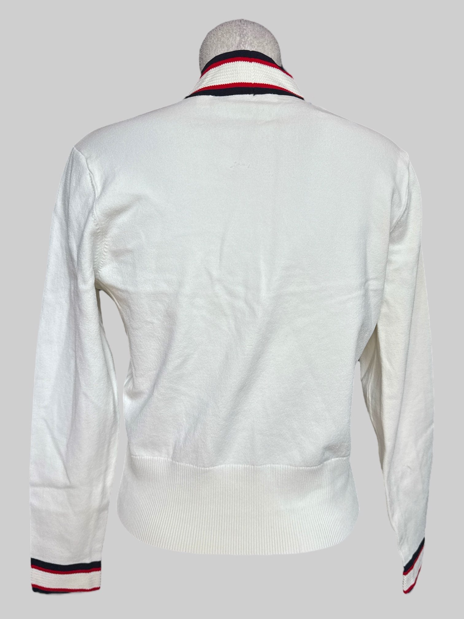 L Ted Baker white button up cardigan with red and blue details and gold color buttons
