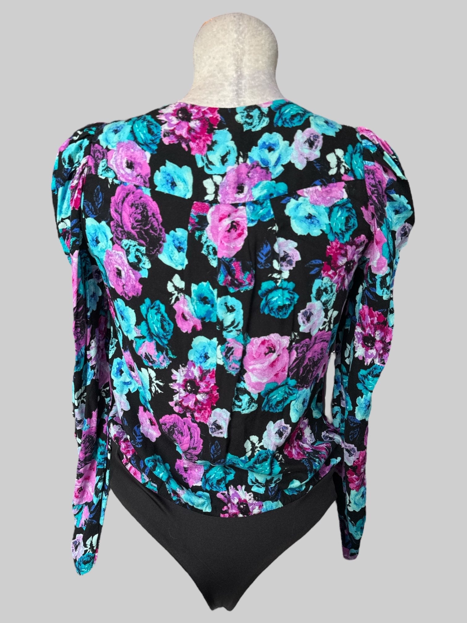 M NWT Nordstrom black body suit with blue and purple, pink florals and pleated sleeves