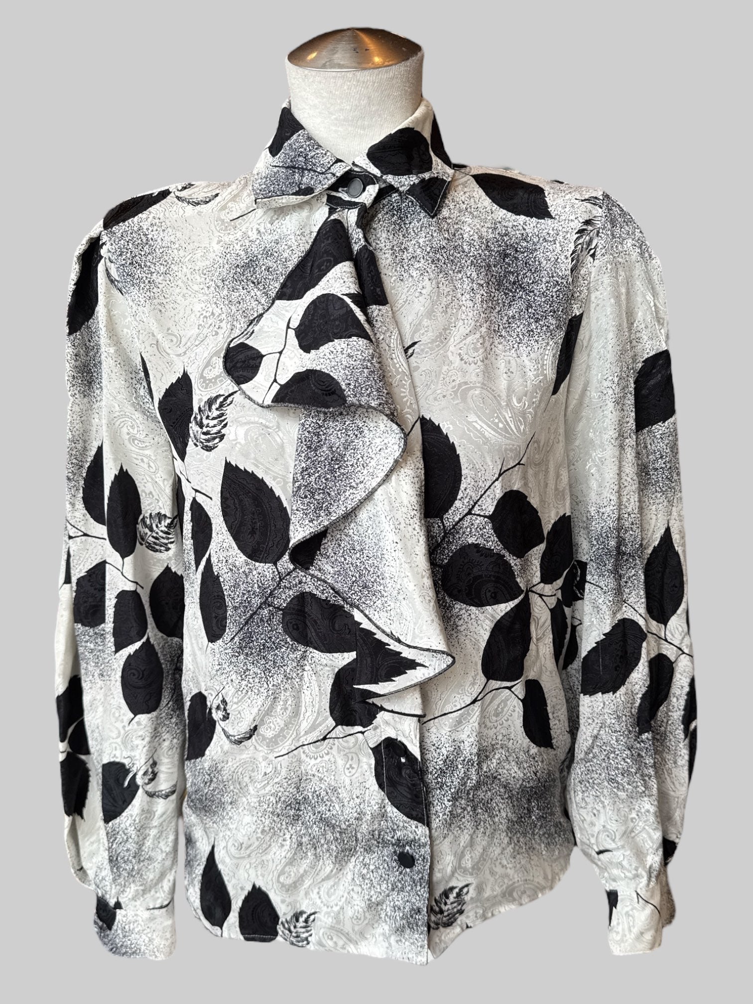 M Vintage white button up with black botanicals and speckles, textured paisley pattern, and front ruffle