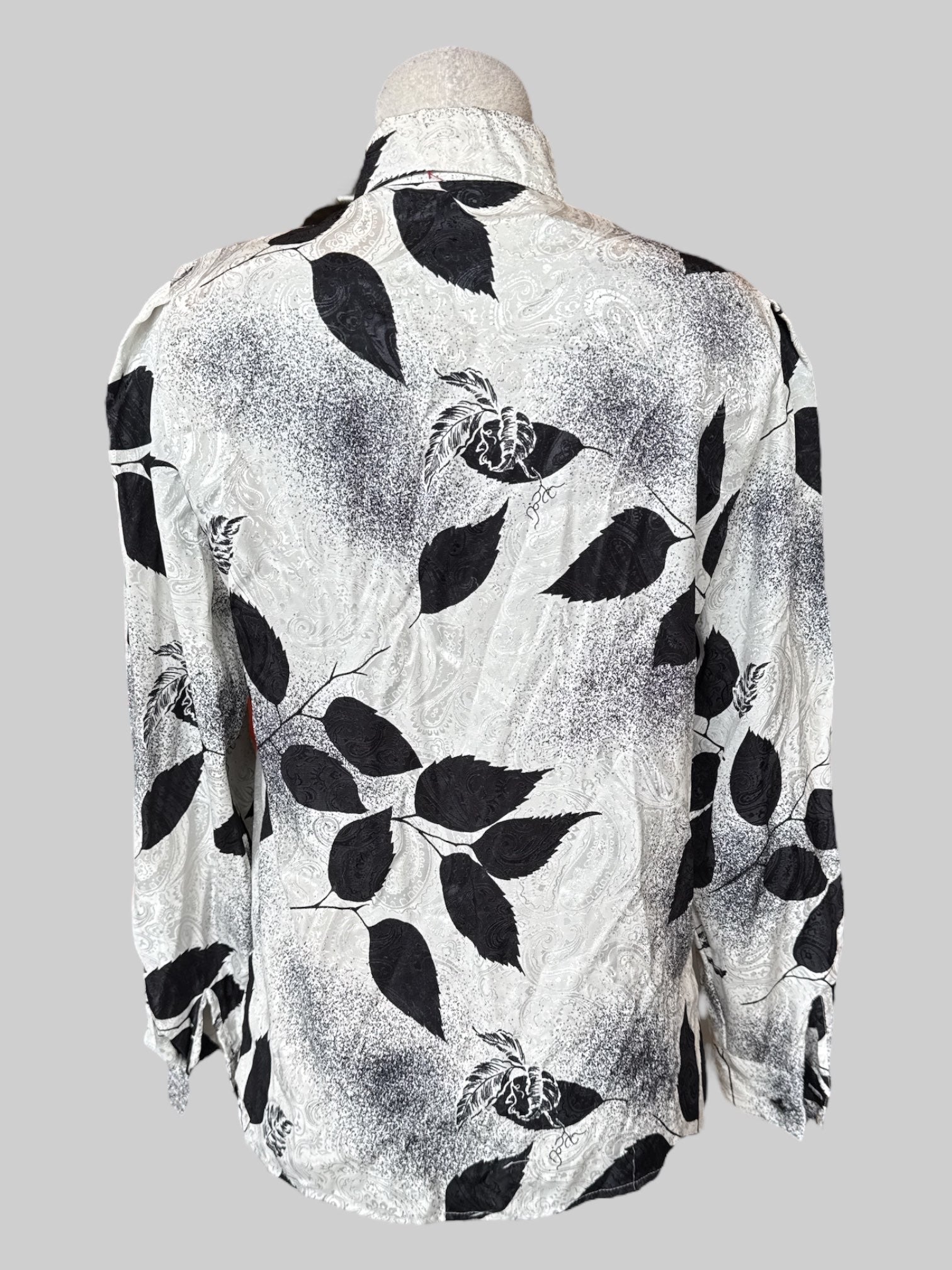 M Vintage white button up with black botanicals and speckles, textured paisley pattern, and front ruffle