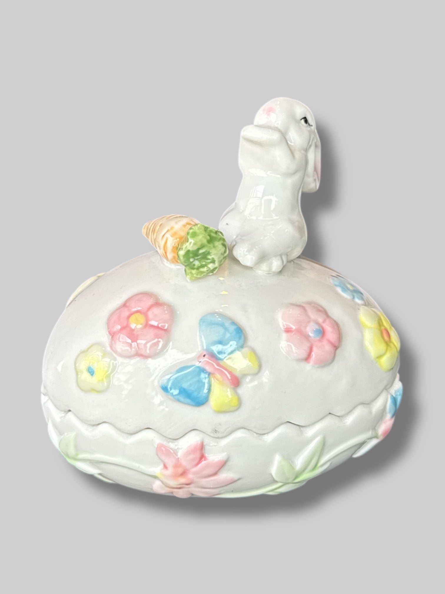 Vintage white egg shaped container with a bunny, florals, and a carrot