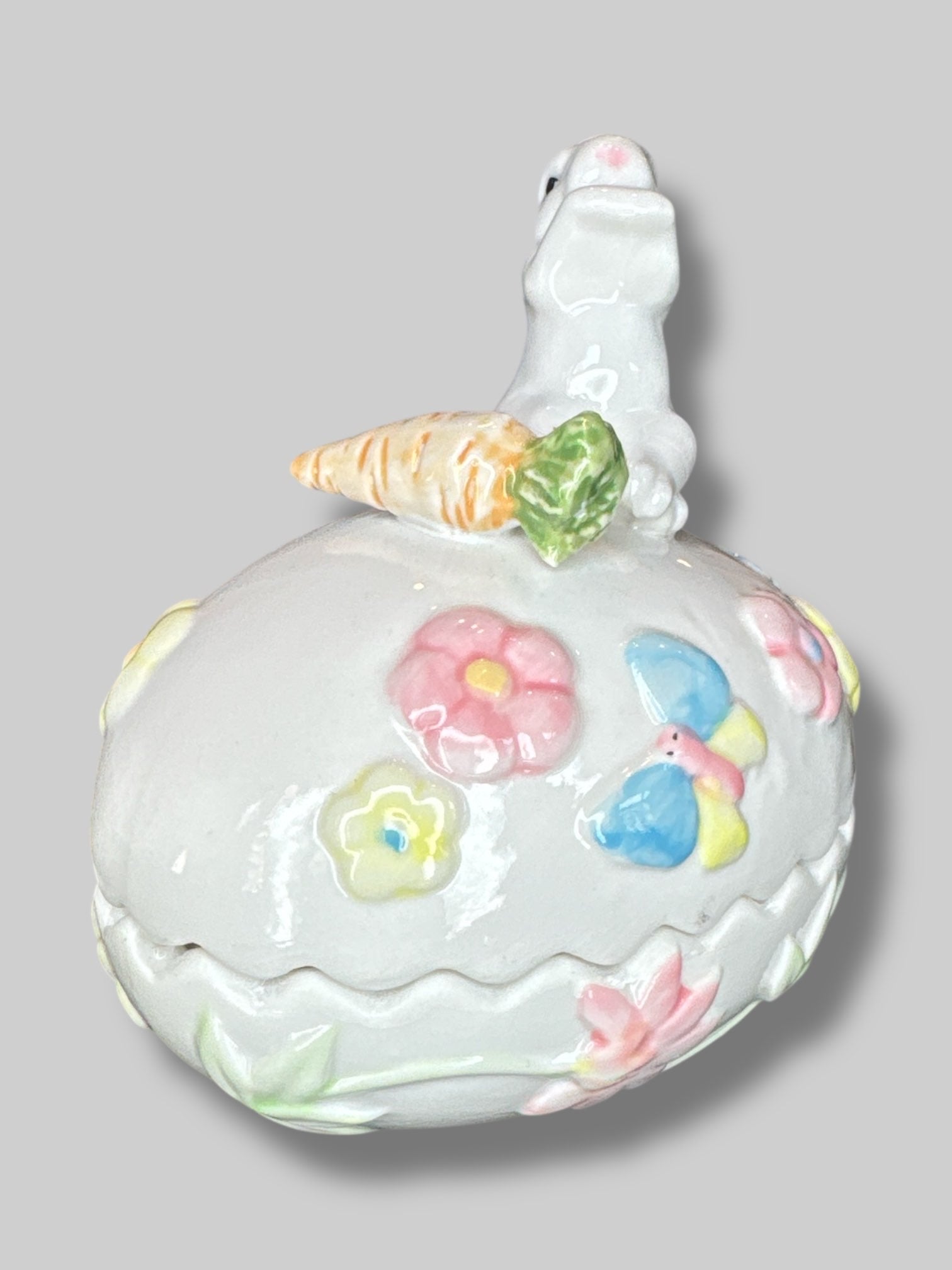 Vintage white egg shaped container with a bunny, florals, and a carrot