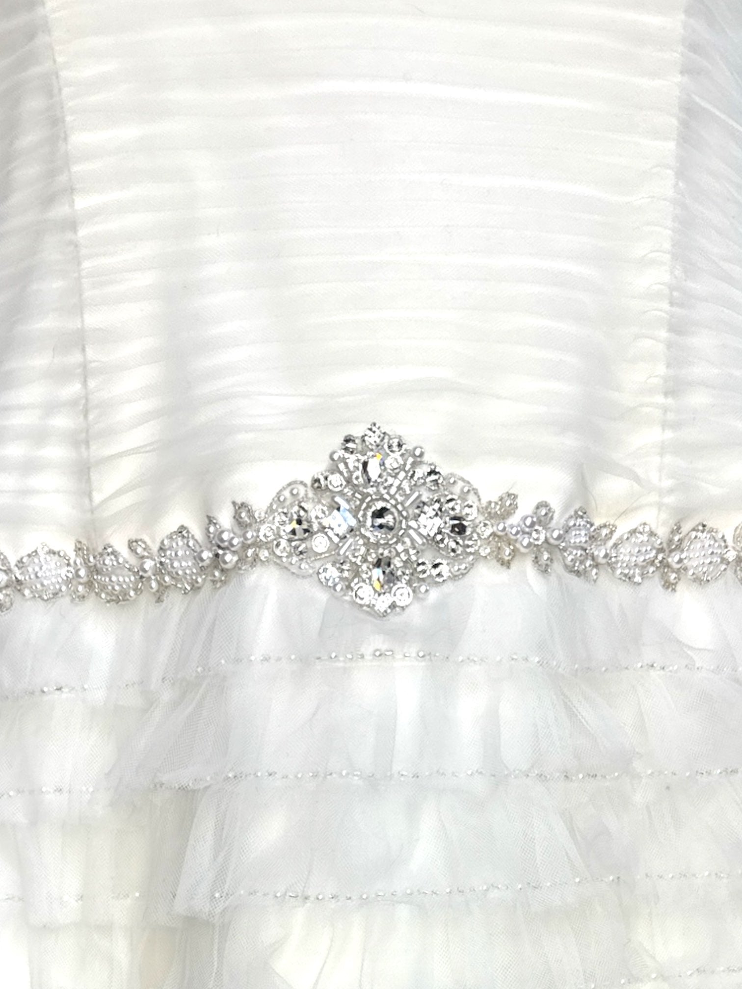 L David’s Bridal white wedding reception type dress with tule ruffles that become sheer at the bottom, pearl and stone belt, boning, and ruched bodice