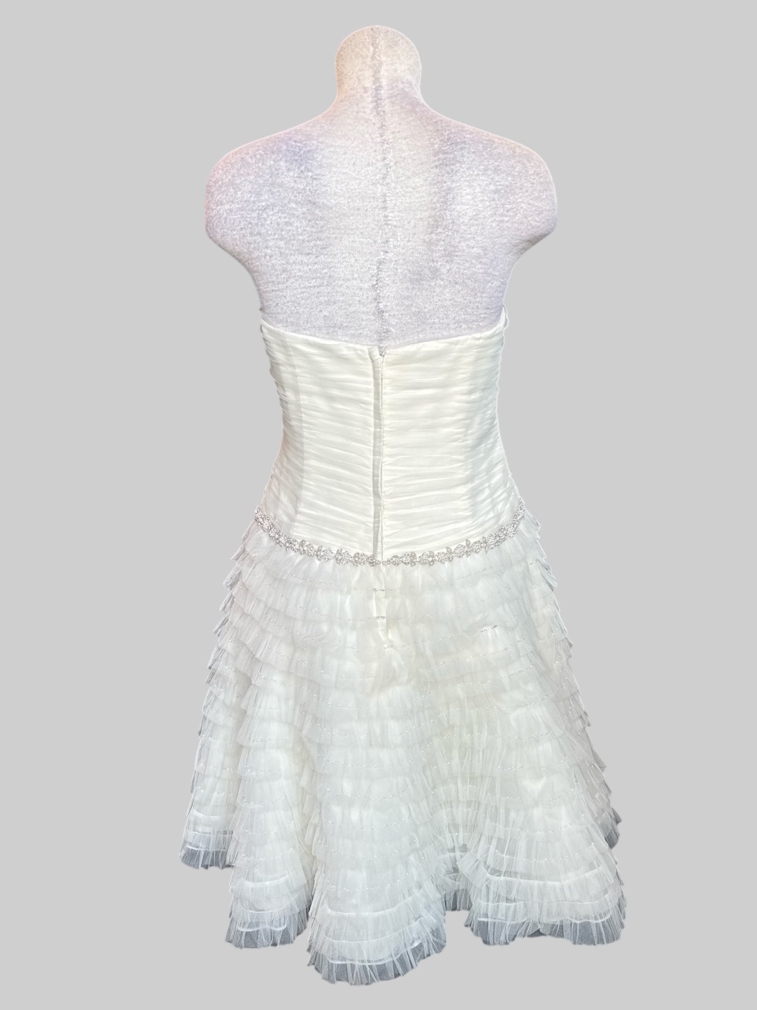 L David’s Bridal white wedding reception type dress with tule ruffles that become sheer at the bottom, pearl and stone belt, boning, and ruched bodice