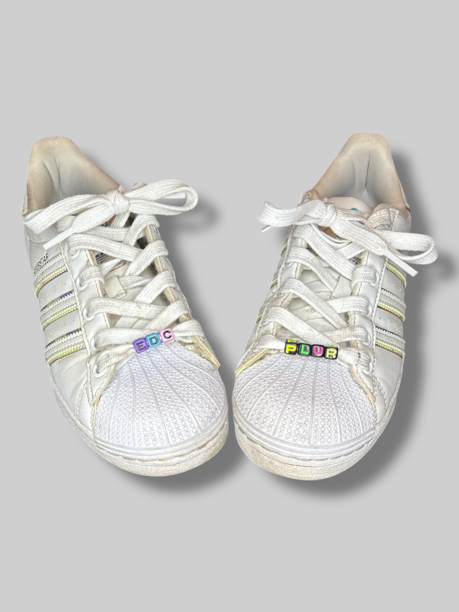 Size 5 1/2 White Adidas sneakers with holographic details, and festival beading on laces