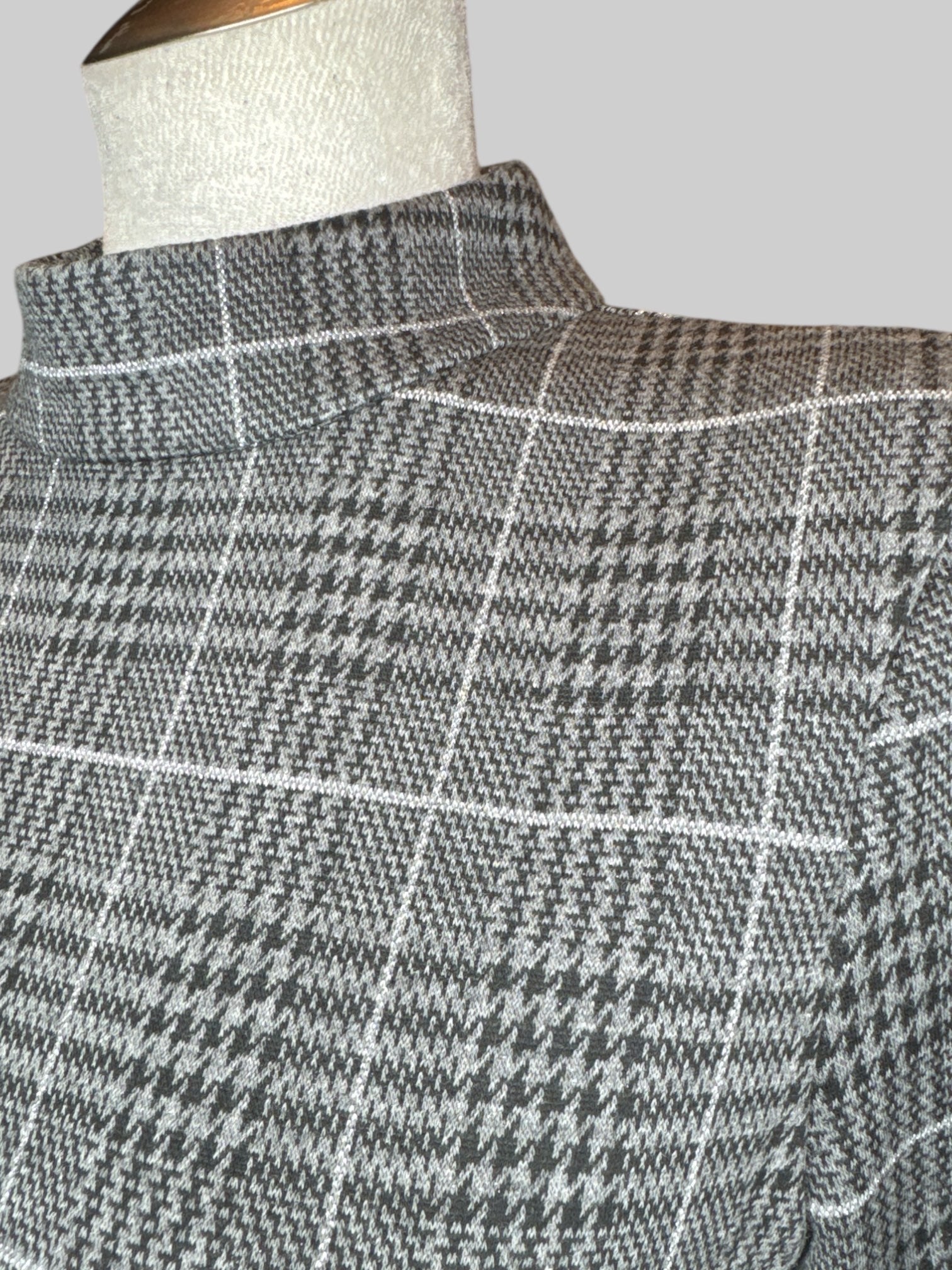 L Black, grey, and silver metallic plaid and houndstooth patter long sleeve top with mock neck, and zipper in back