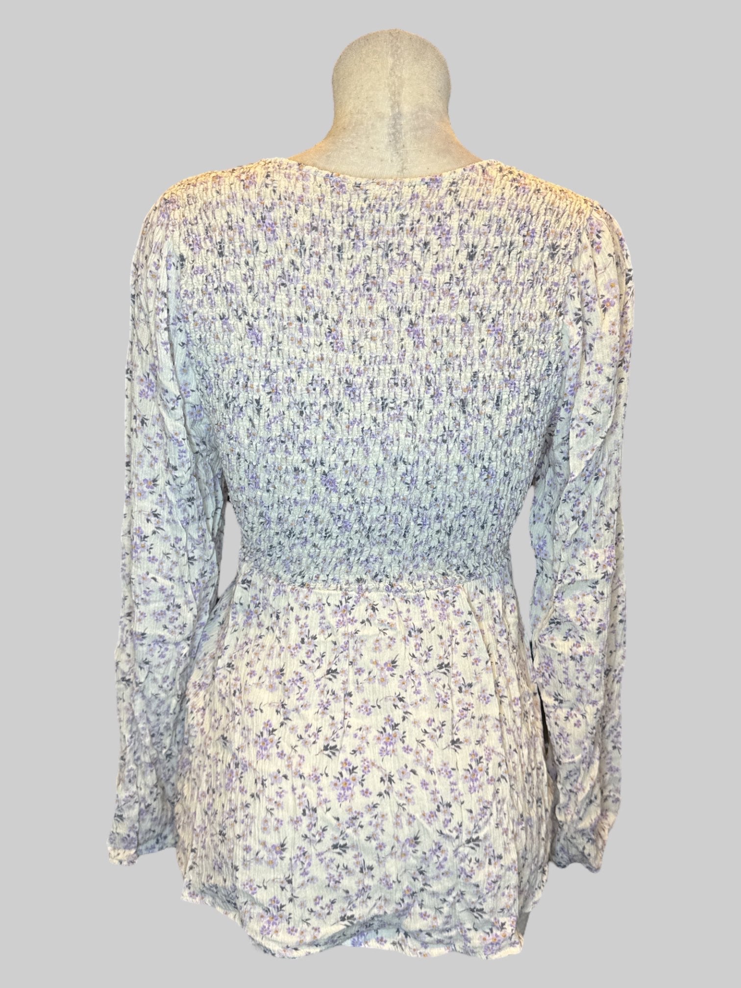 1X white long sleeve shirt with purple florals, and shirred bodice