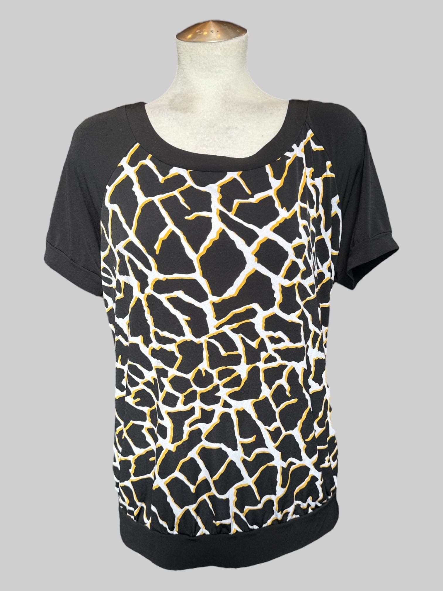 1X black, white, and yellow top with geometric pattern