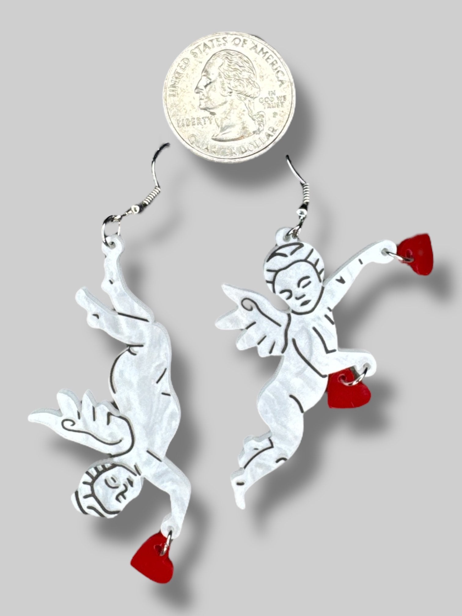 white cherub earrings with red hearts