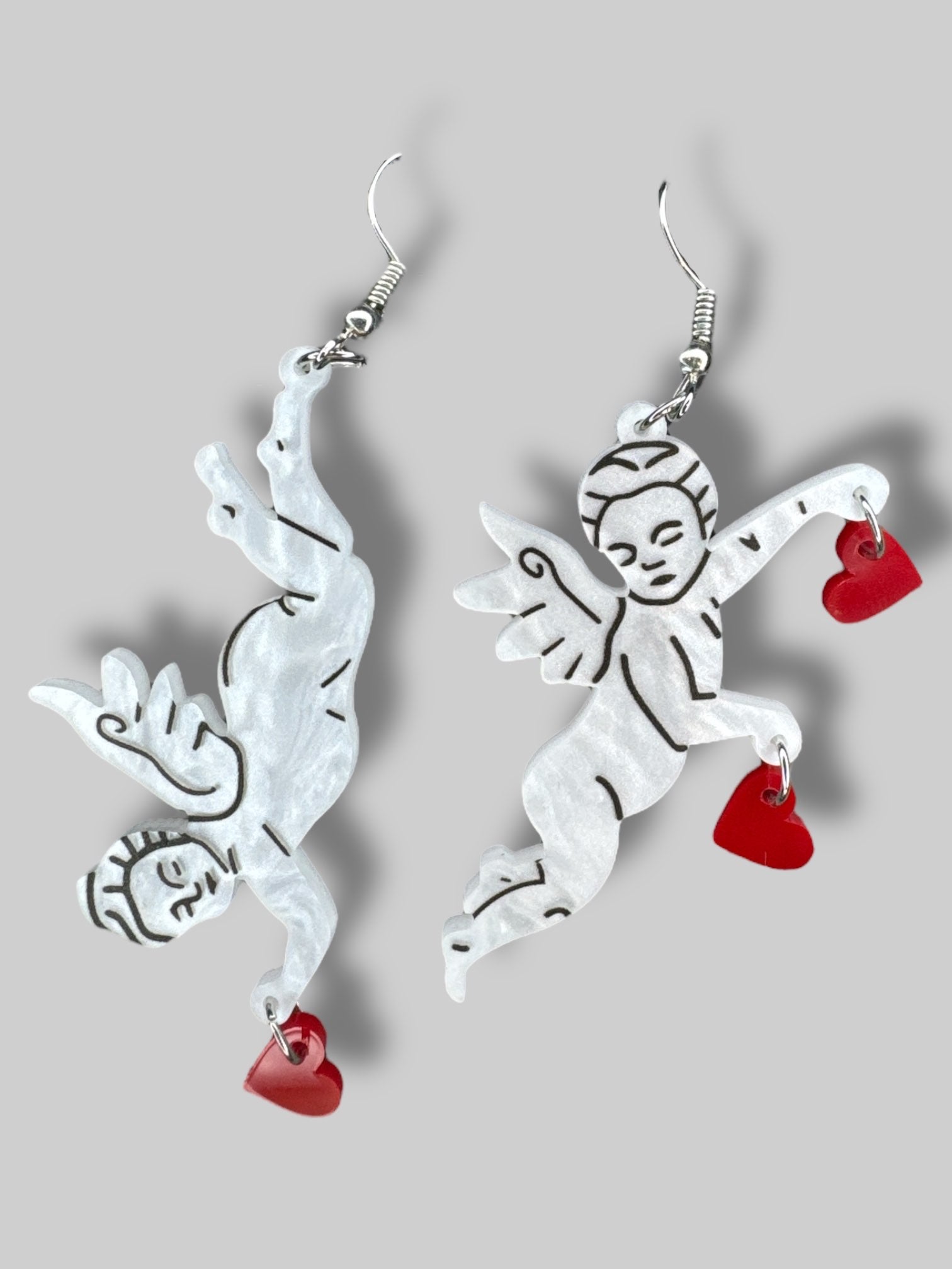 white cherub earrings with red hearts