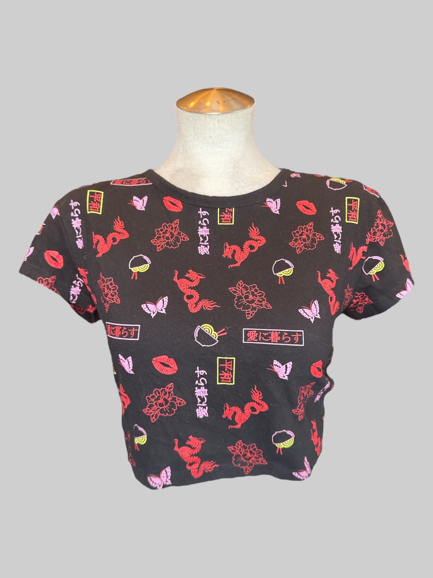 XL black crop top with red, pink, and yellow graphics, open back, and tie