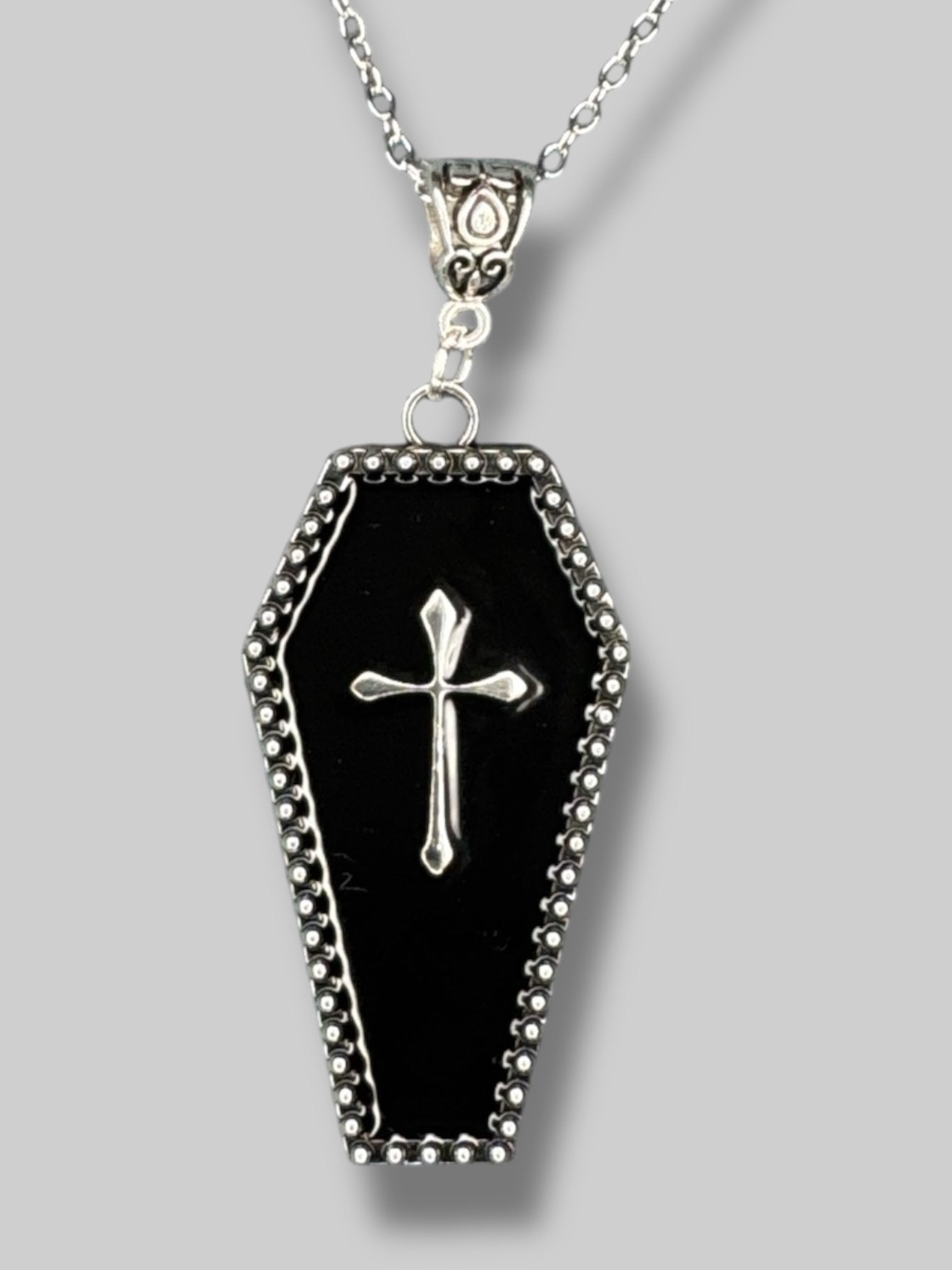 Silver tone necklace with black coffin pendant