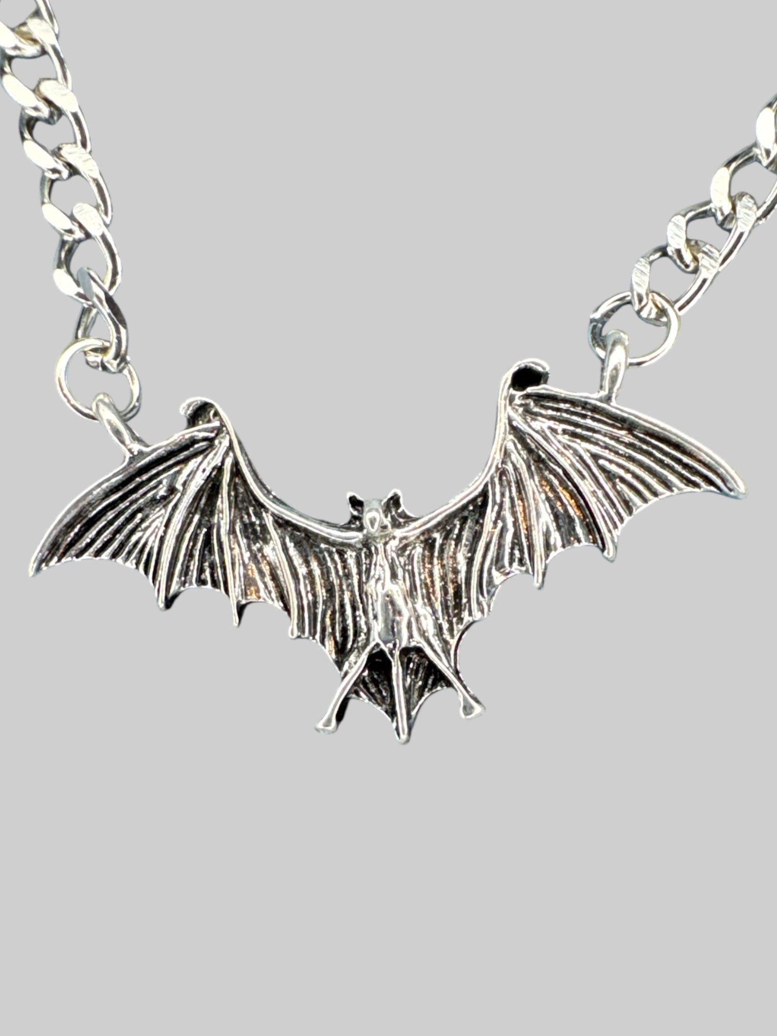 Silver tone bat necklace