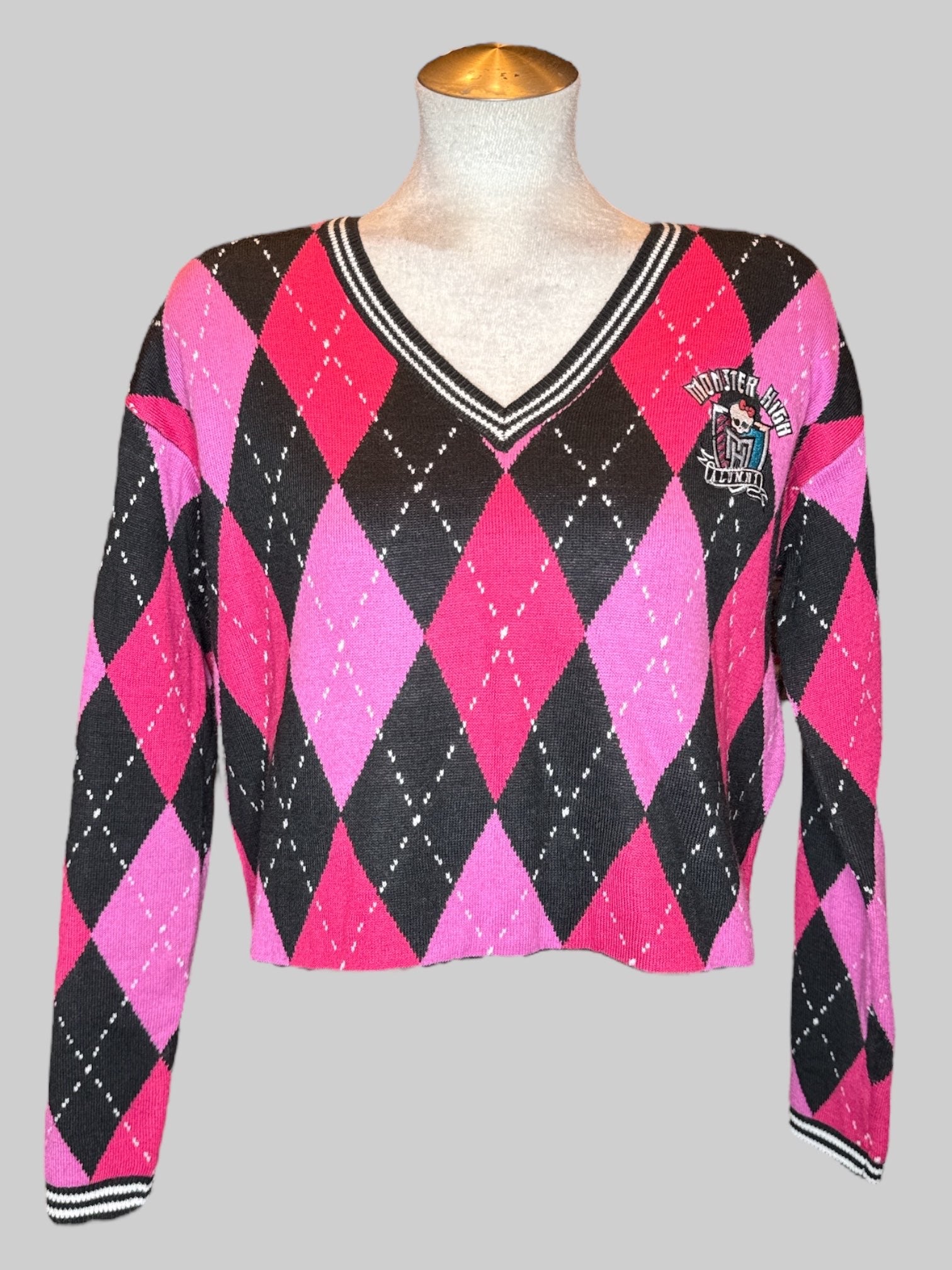 S Monster High pink, black, and white argyle pattern cropped sweater