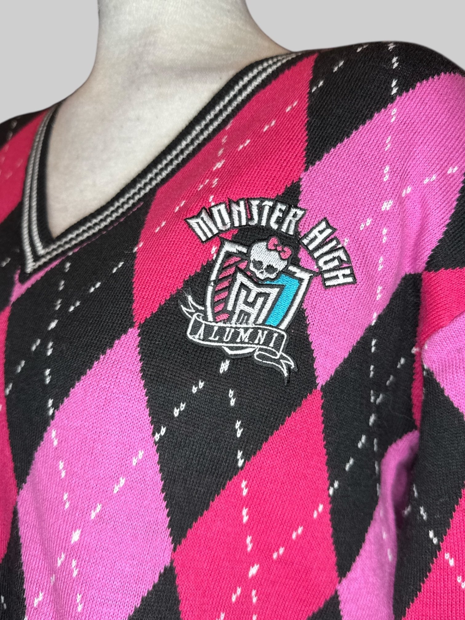 S Monster High pink, black, and white argyle pattern cropped sweater