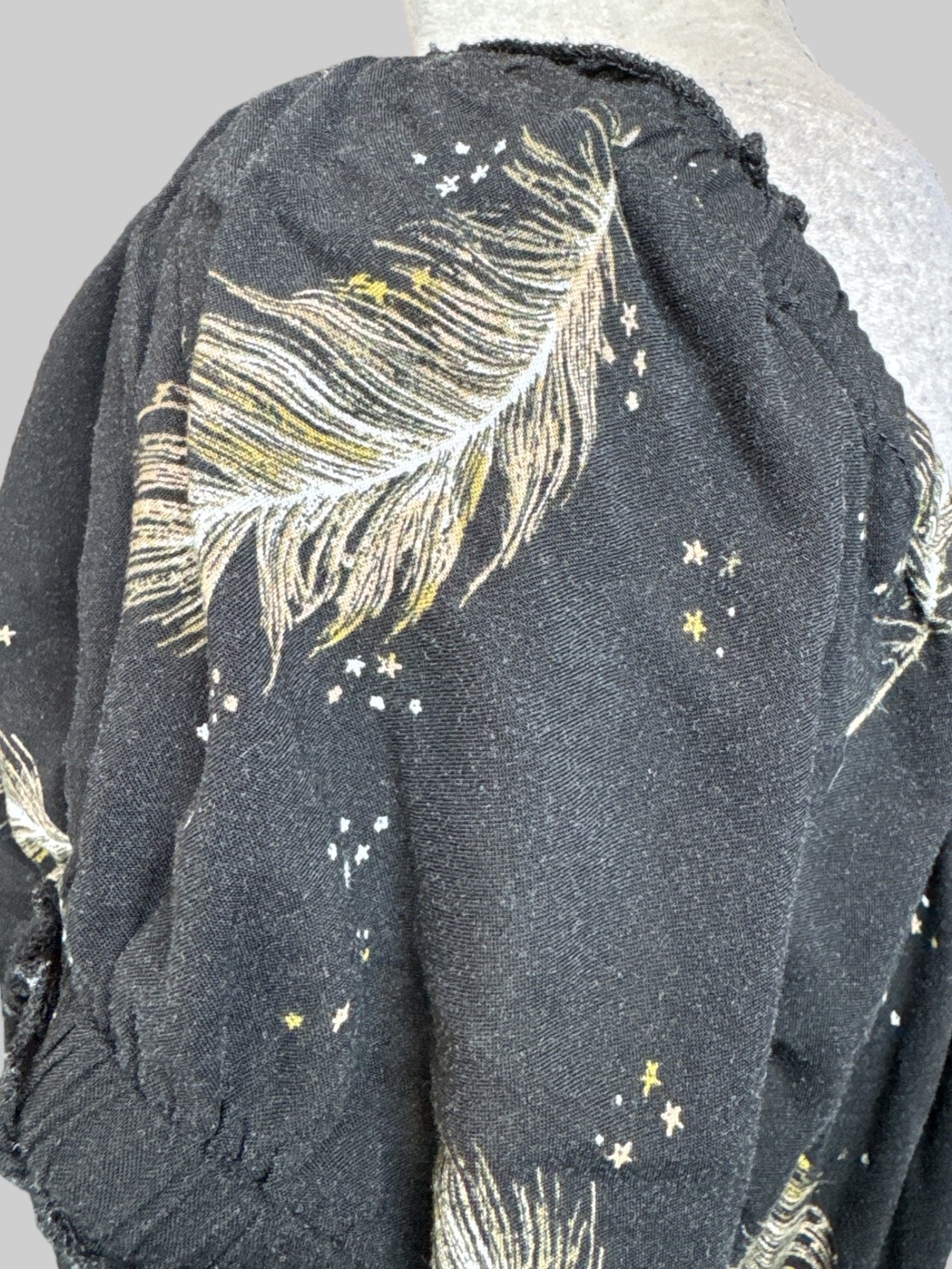 1X Black dress with drawstring waist, ballon sleeves, and greenish brown feather pattern with little stars