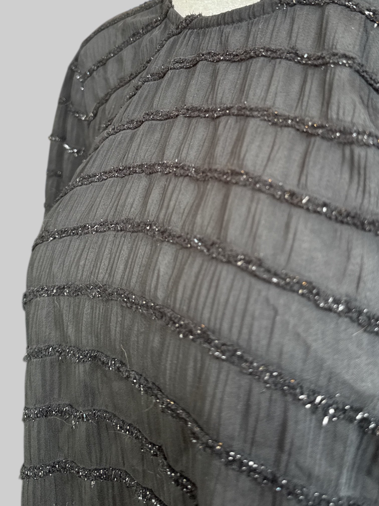 1X Sheer black top with balloon sleeves, keyhole back, and textured metallic stripes
