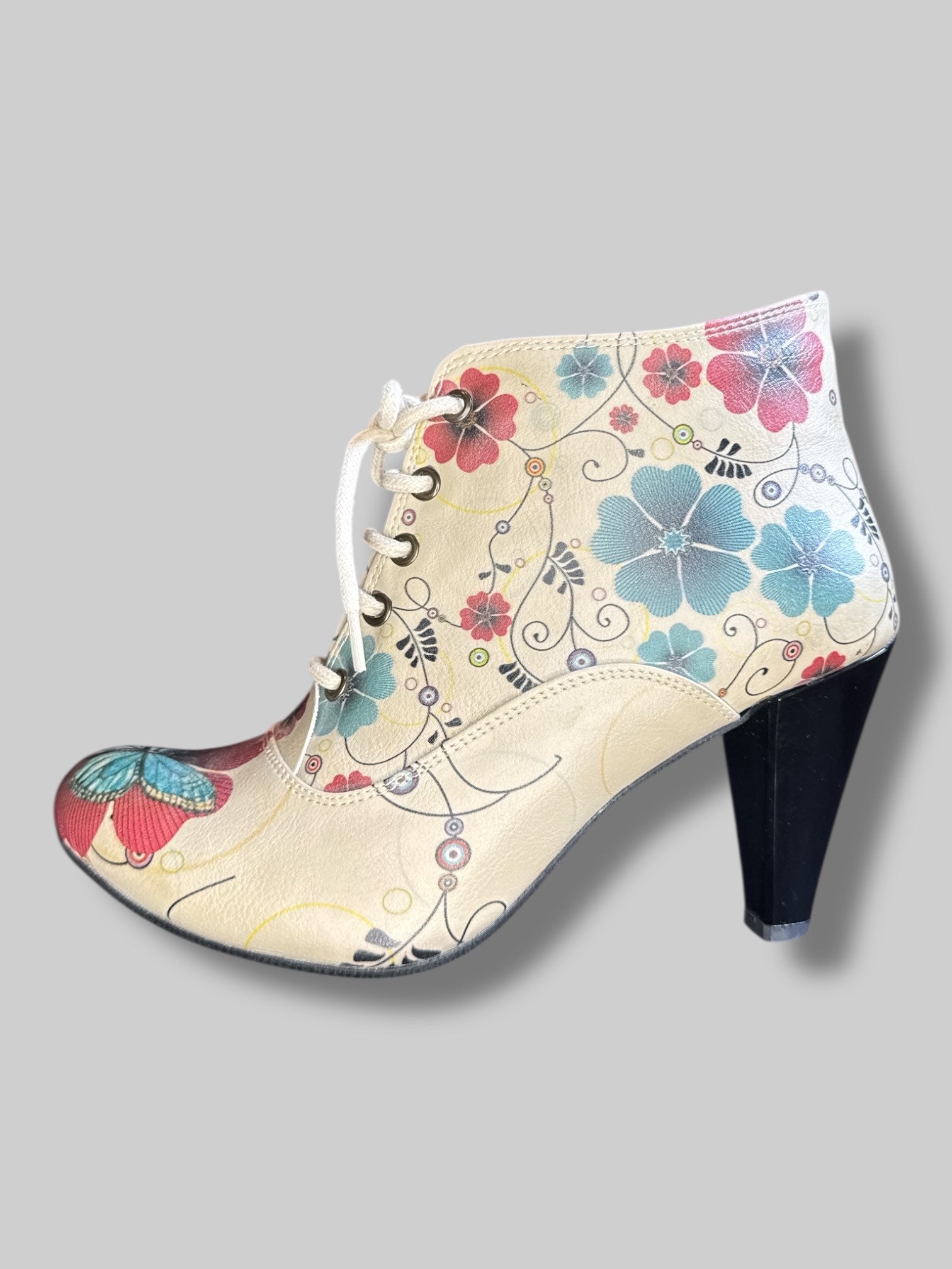 Beige boot heels with lacing, red and blue florals, and zippers on sides
