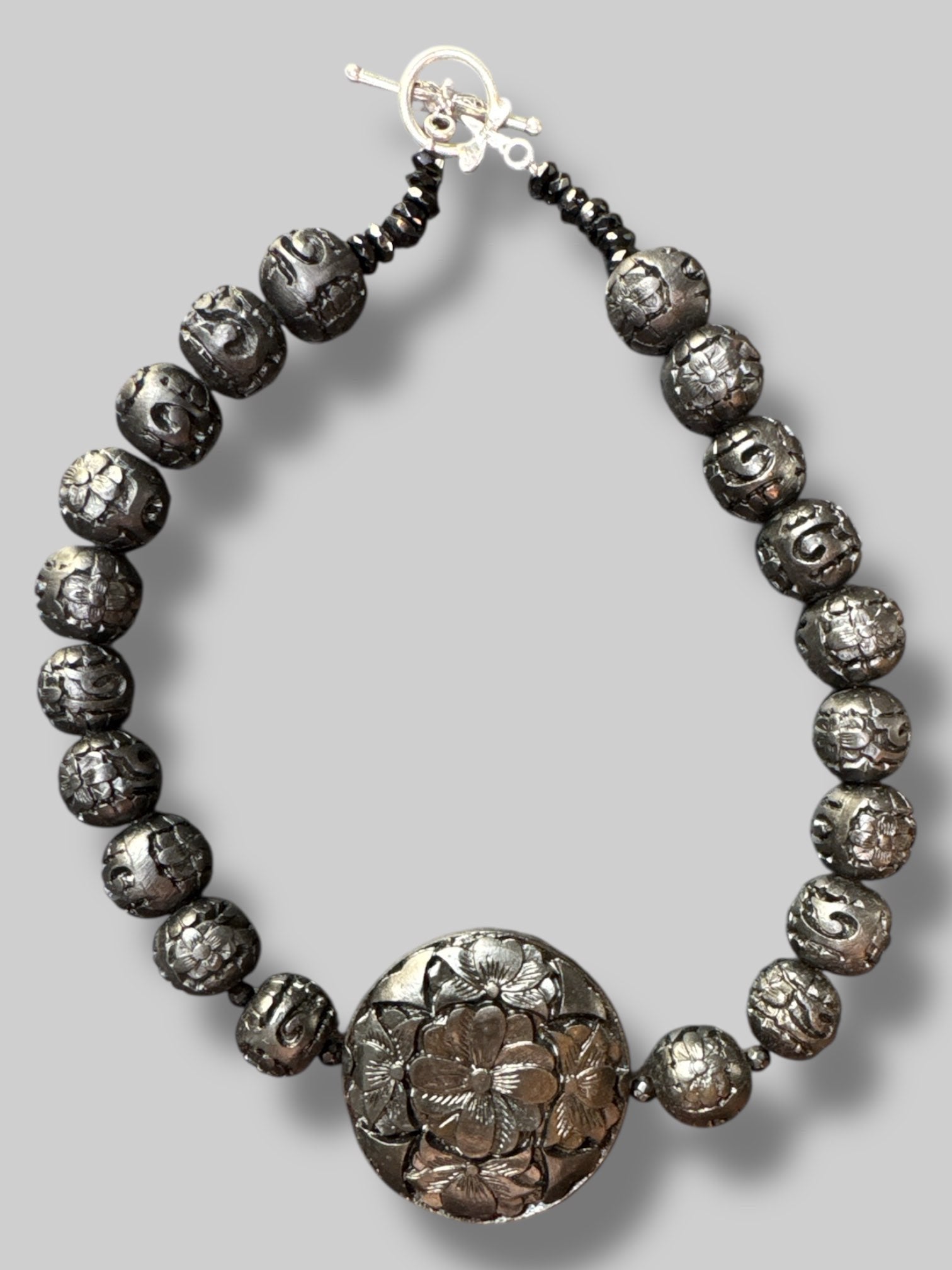 Black beads with carved florals