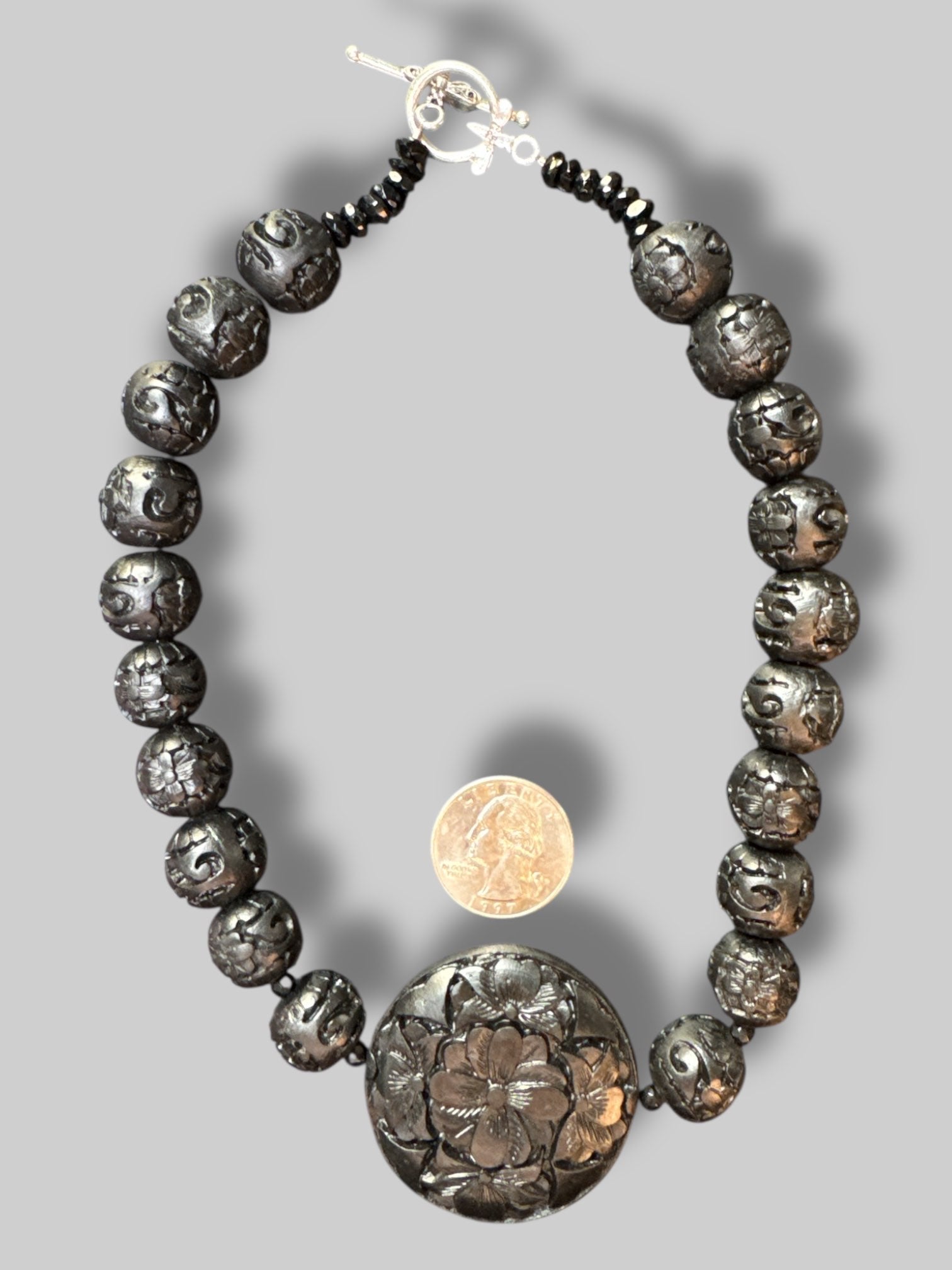 Black beads with carved florals