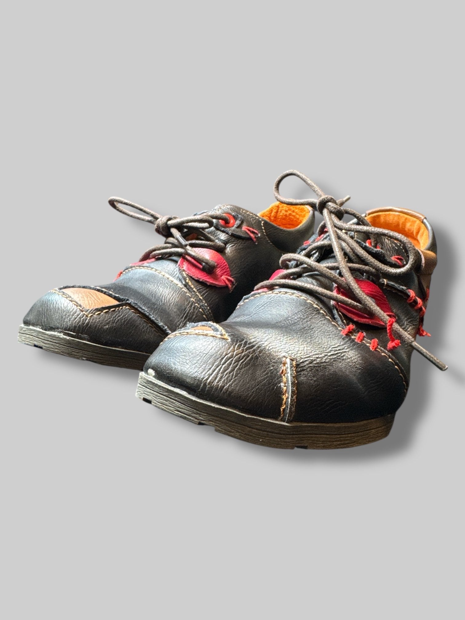 Size 8.5 black shoe with red stitching