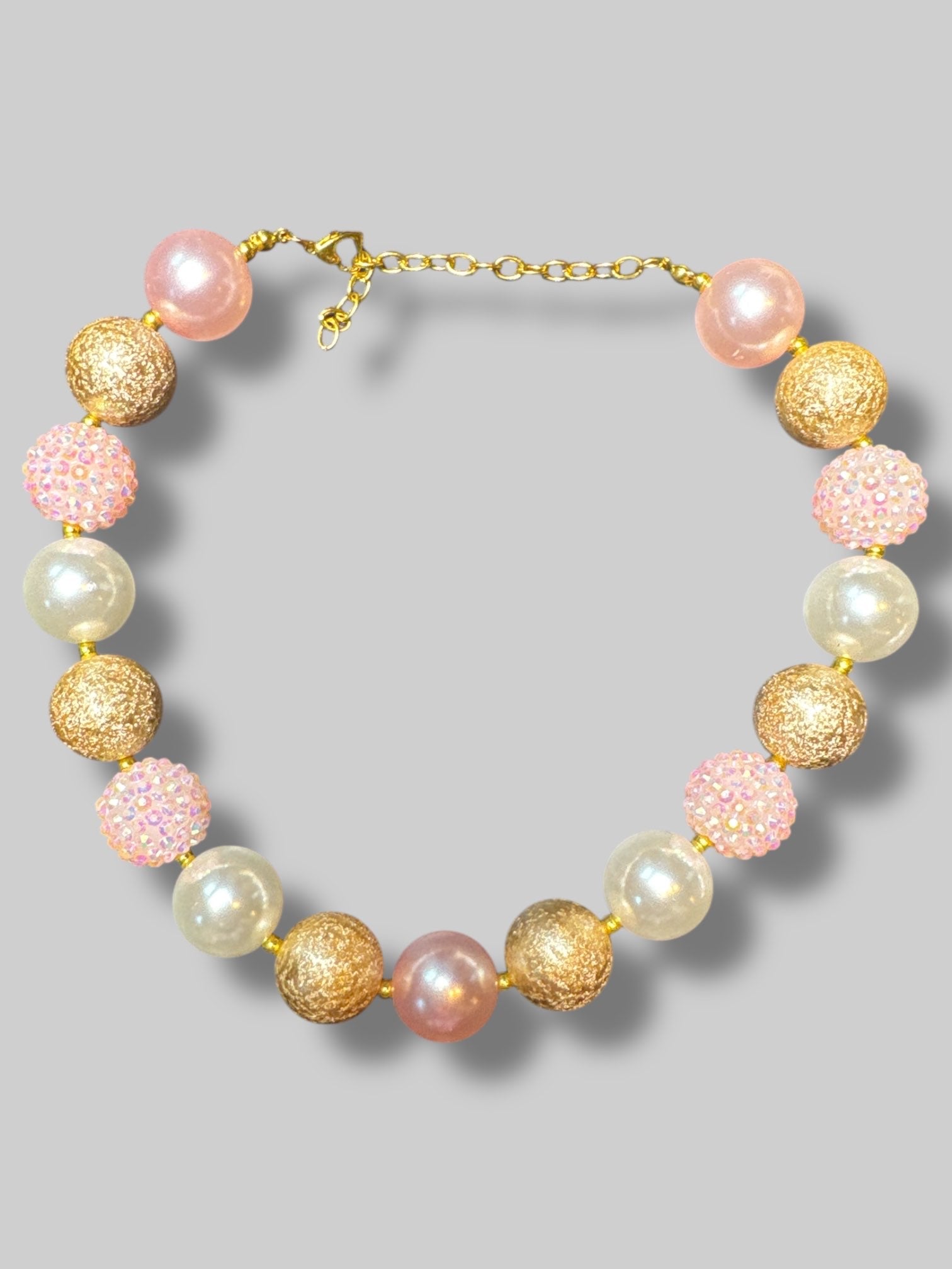 Matching necklace and bracelet with big chunky pink, white, and gold beads