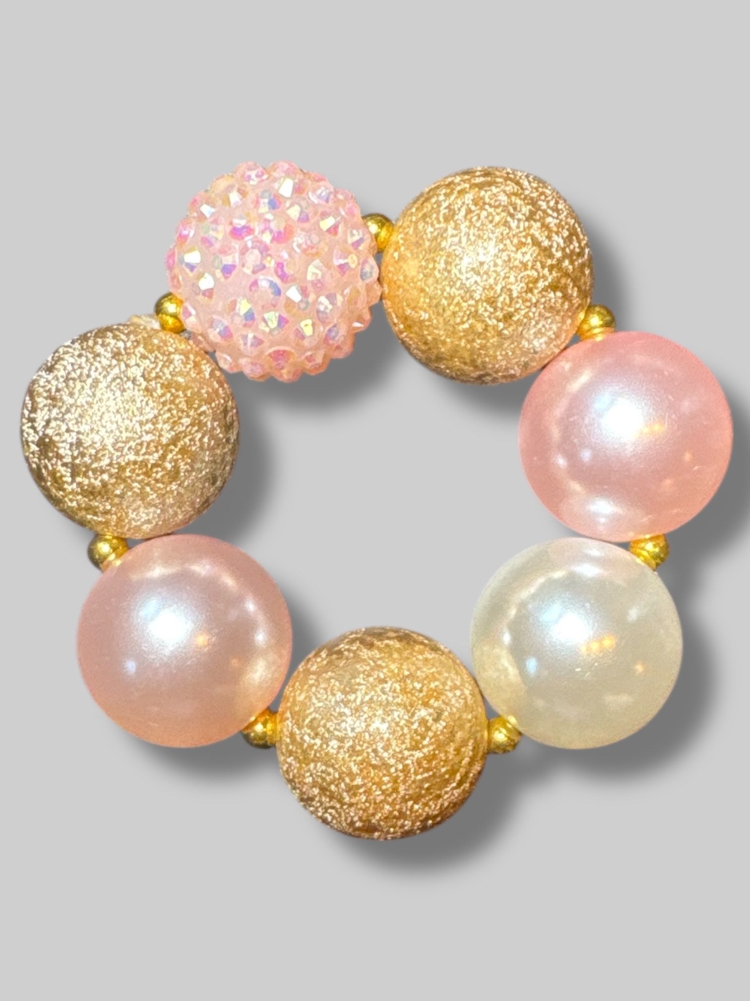 Matching necklace and bracelet with big chunky pink, white, and gold beads