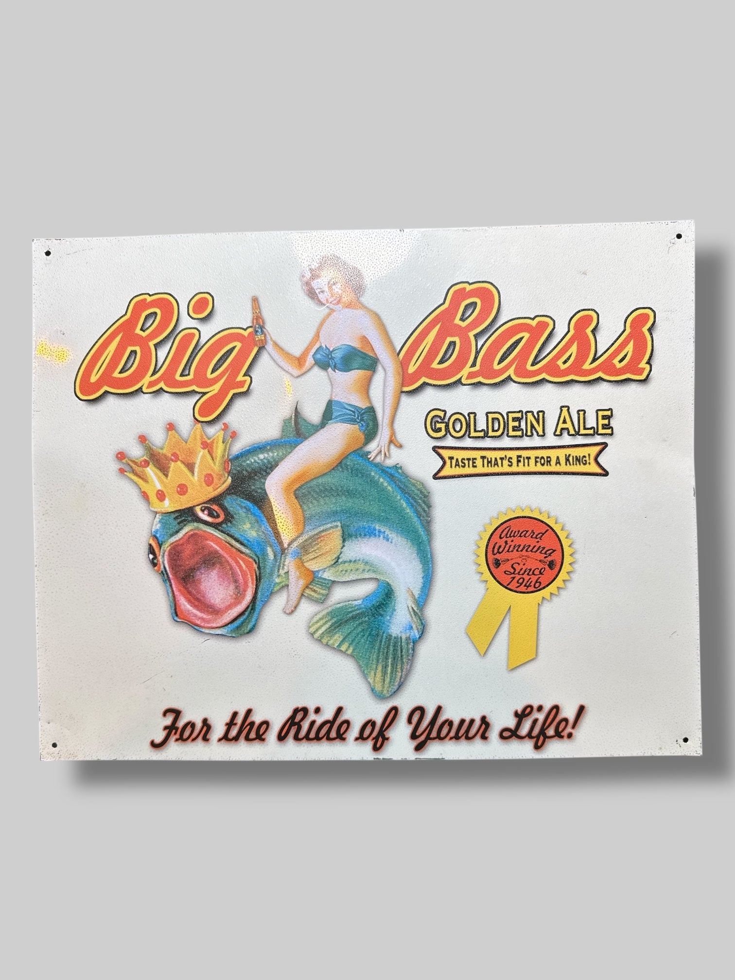 White metal sign with fish and lady