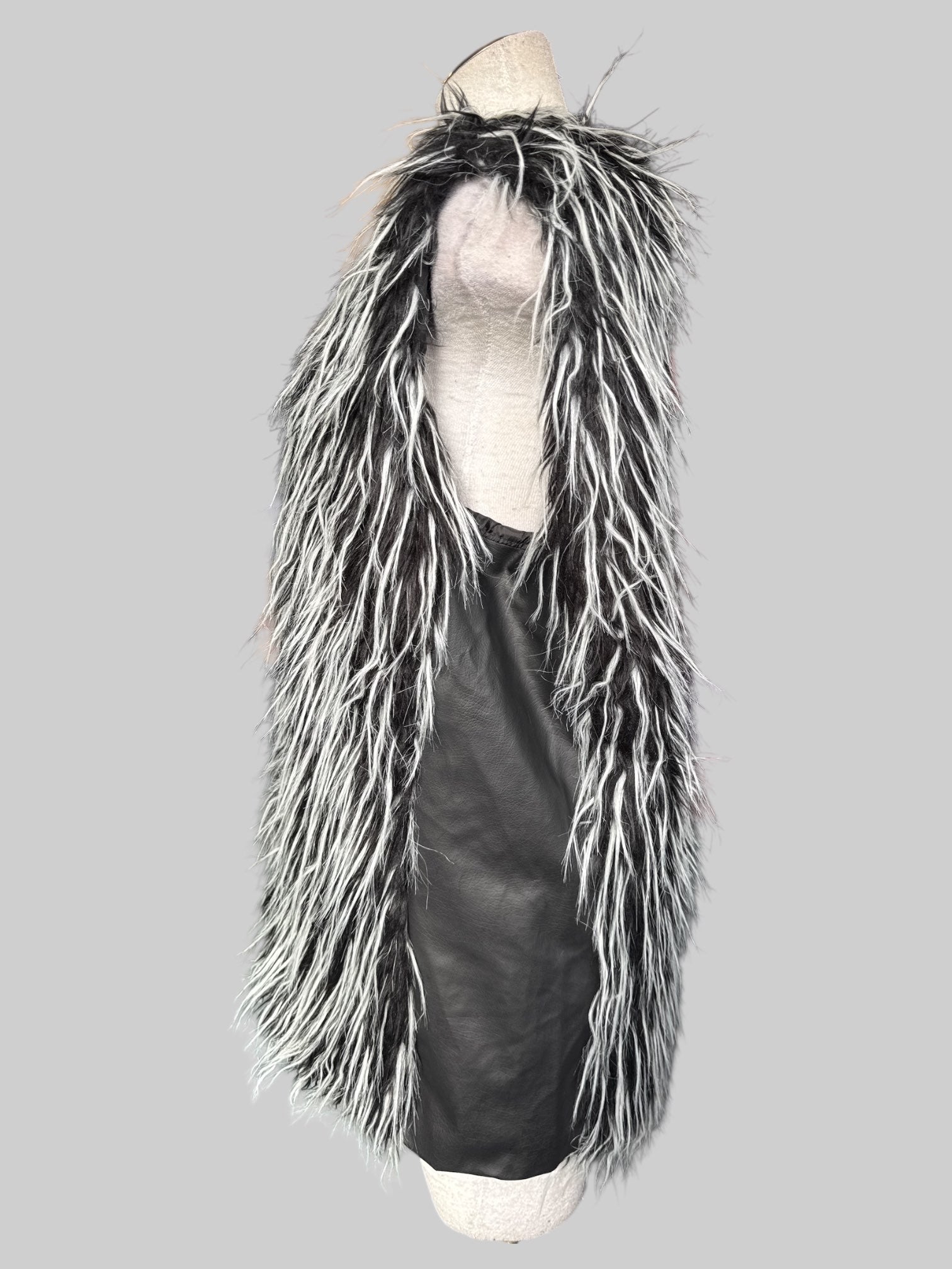 0X furry black and white sleeveless cardigan with clasps instead of buttons and pleather sides