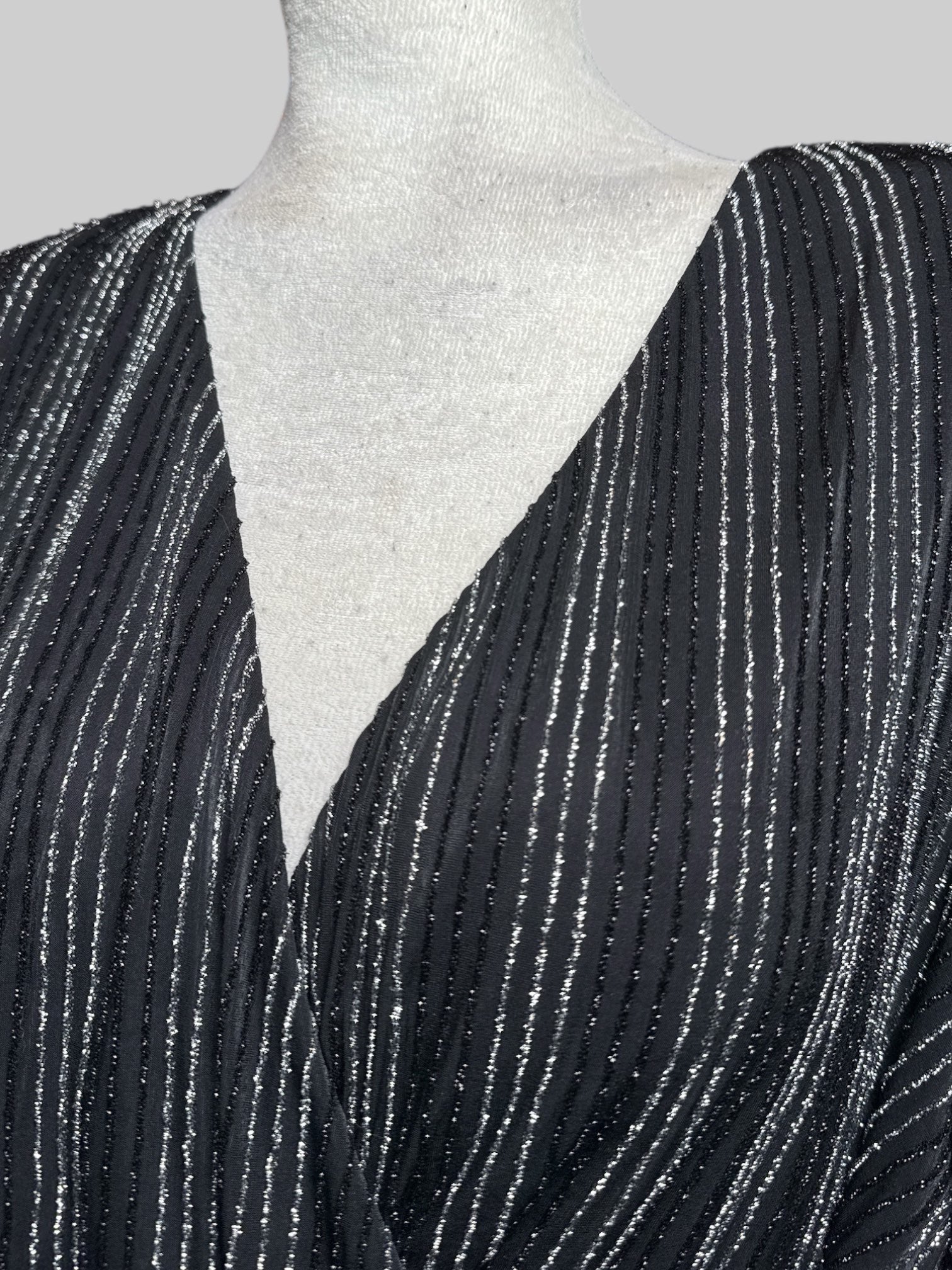 3X black faux wrap dress with black and silver metallic textured stripes and tie belt