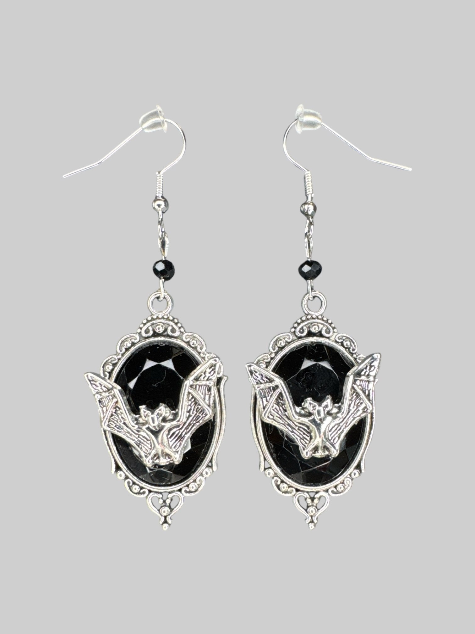 Dangly ornate gemstone earrings with metal bats