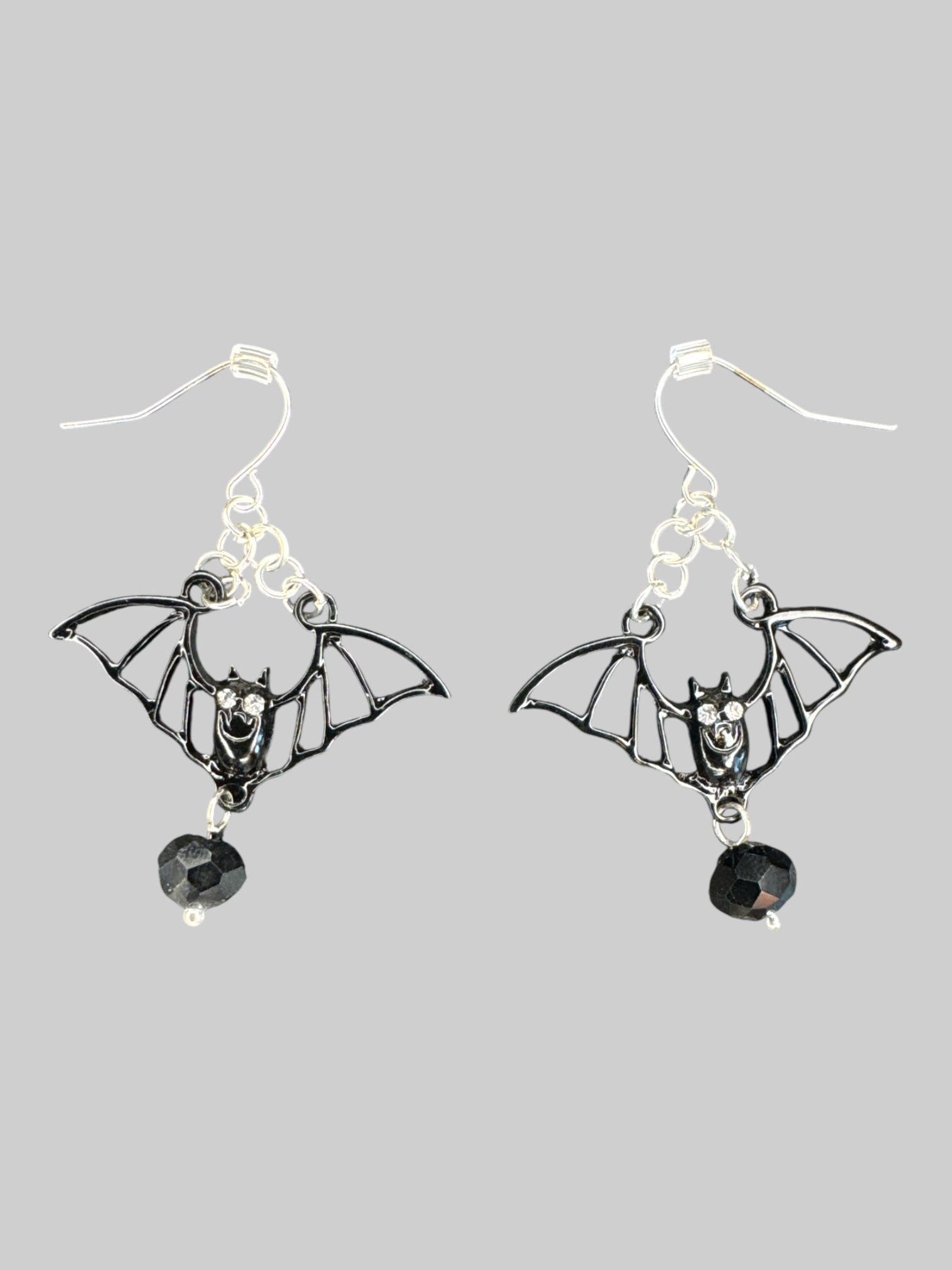 Black bat earrings with chain detail, rhinestone eyes, and bead at bottom