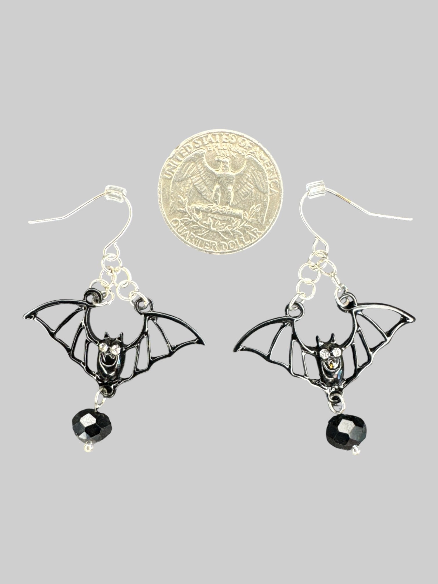 Black bat earrings with chain detail, rhinestone eyes, and bead at bottom