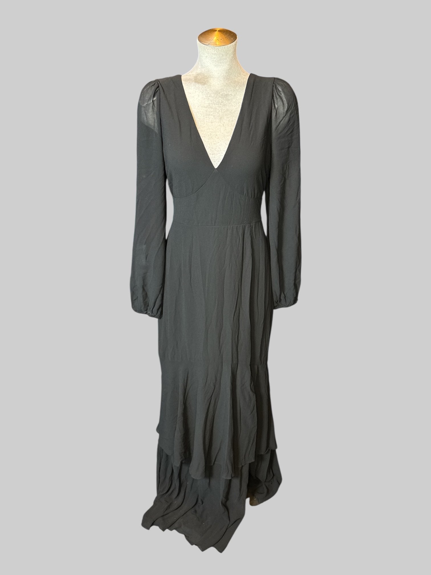 M black long balloon sleeve dress with  flowy bottom, and zipper and tie on back