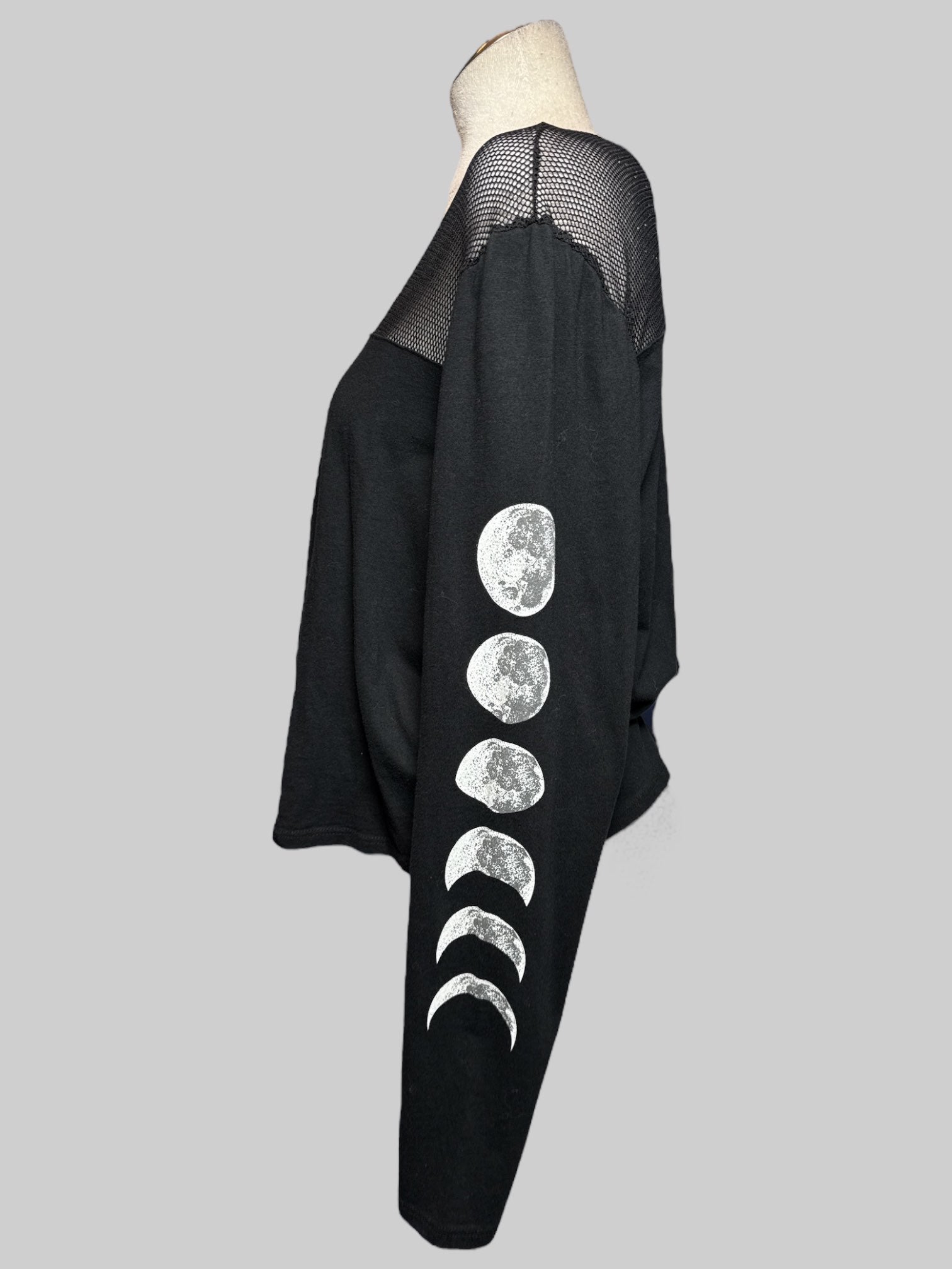 2X black long sleeve top with mesh chest and moon phase graphic on arms