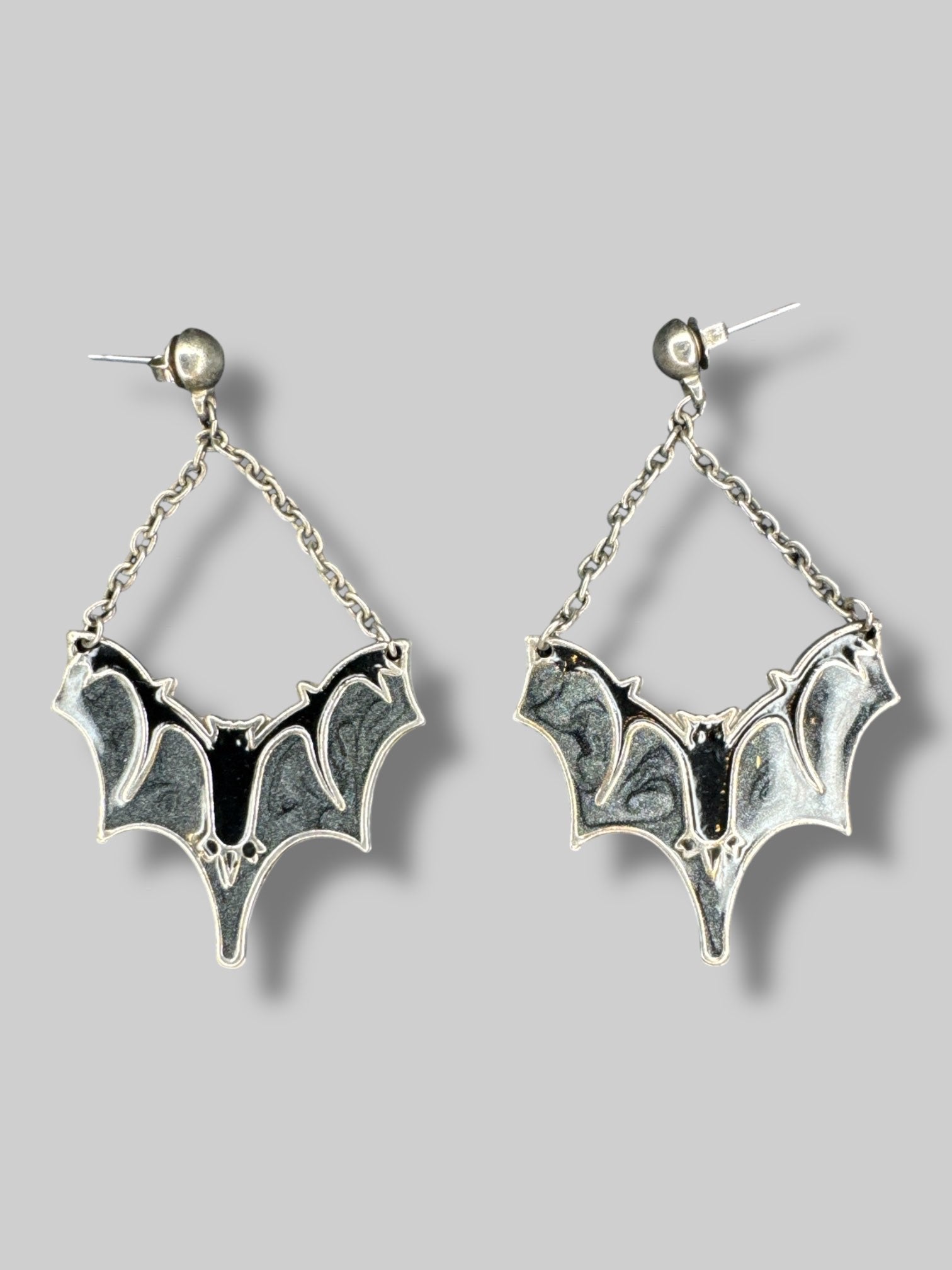 Metal dangle bat earrings with grey sparkly and black resin
