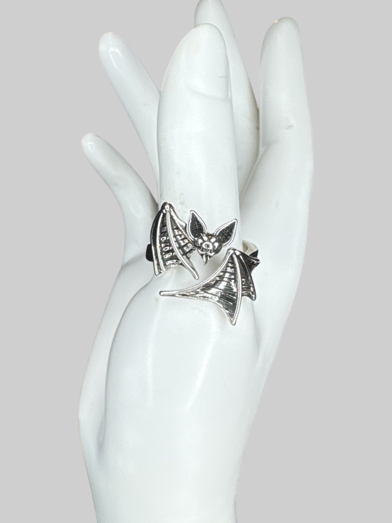Adjustable silver tone wraparound bat ring