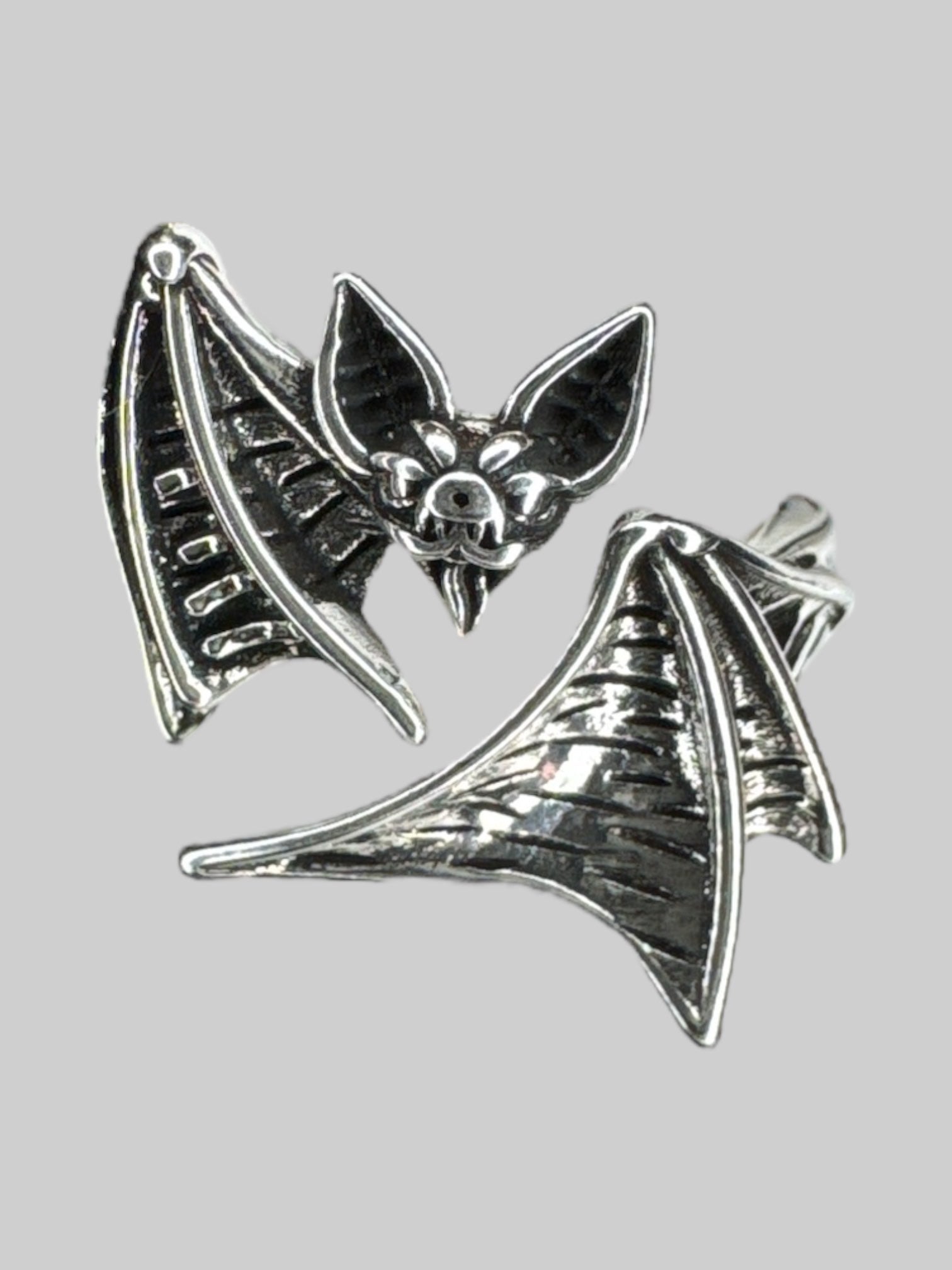 Adjustable silver tone wraparound bat ring