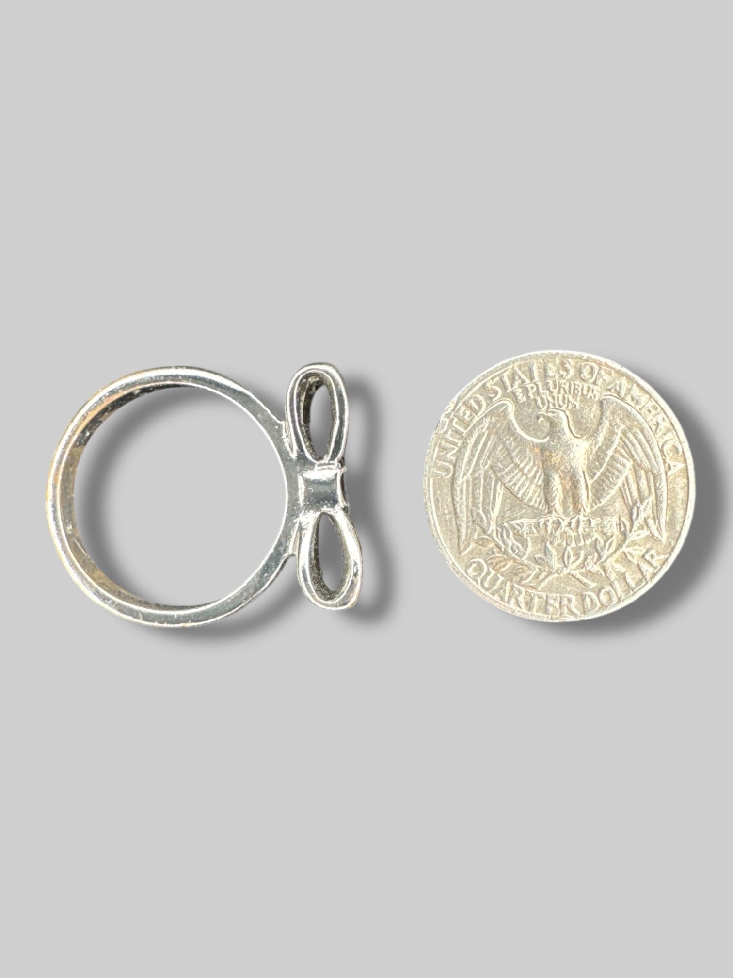 Size 8.5 Silvertone ring with black resin bow